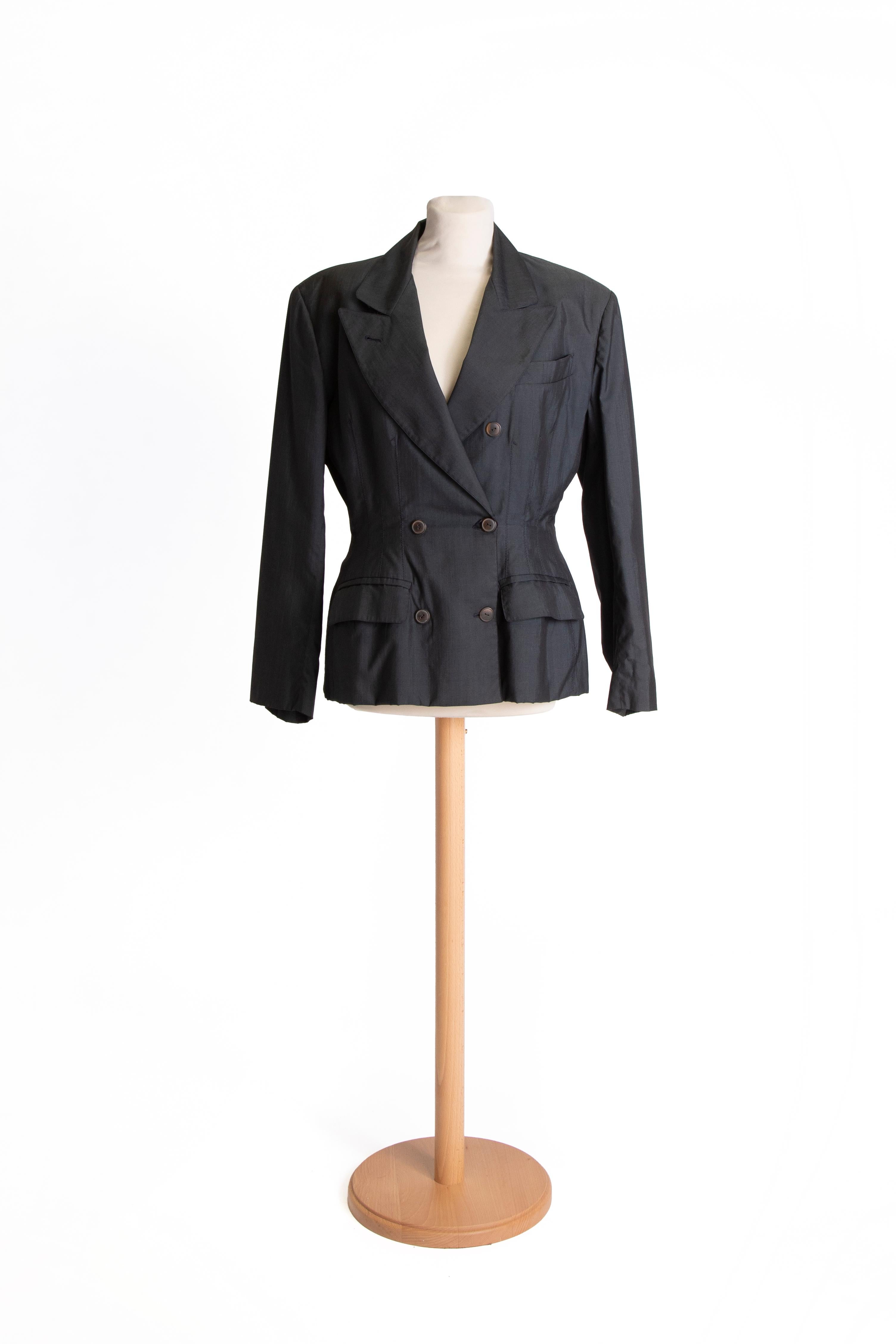1980s Double-breasted charcoal fitted Jean Paul Gaultier blazer, tight at the waist with decorative pleats on the front.

SIZE IT: 44
SIZE USA: 10

MEASURES:
Shoulders: 44 cm
CIRC Bust: 104 cm
CIRC Waist: 80 cm
Length: 65 cm