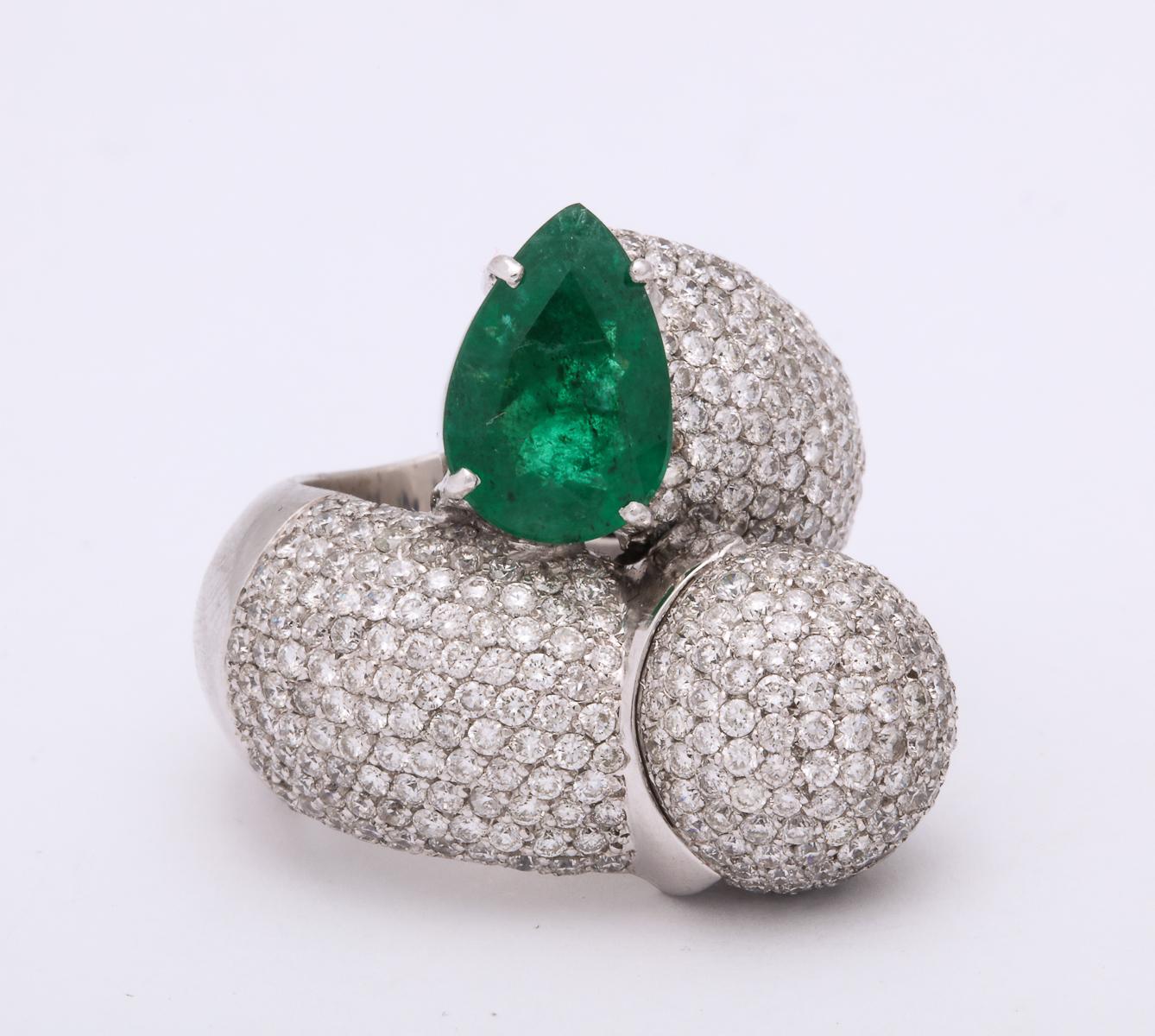 One Ladies 18kt White Gold Large Crossover Bypass Cocktail ring Designed With One Approx. 3 Carat Pear Shaped Emerald. ring Is Also Embellished With Approximately 4 Carts Of Full Cut Diamonds. Large Cocktail Ring Designed In The 1980's In Italy .