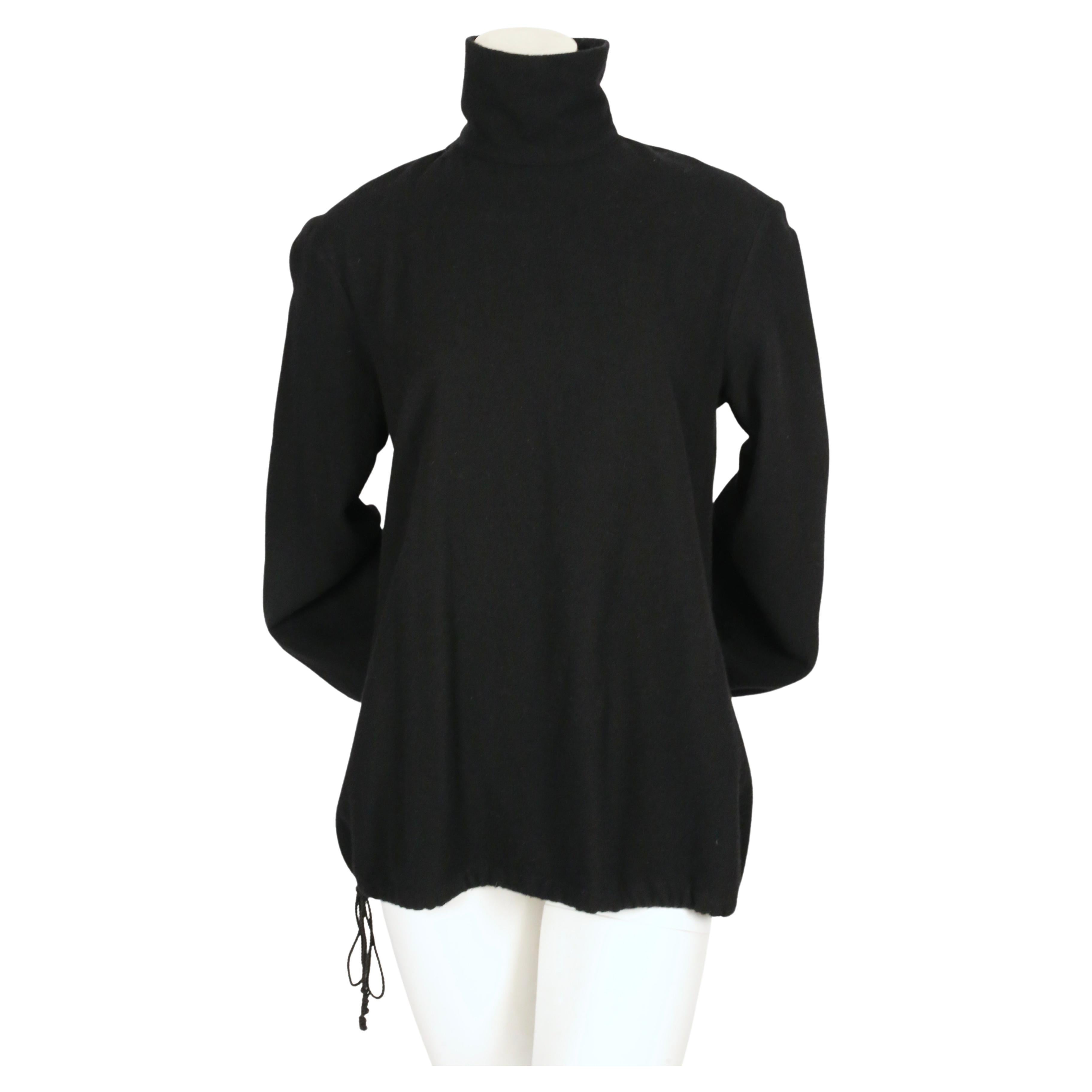 Billowy, jet-black high neck top with button back closure from Dries Van Noten dating to the 1980's. Size 40. Has an oversized/loose fit. Approximate measurements: shoulder 18