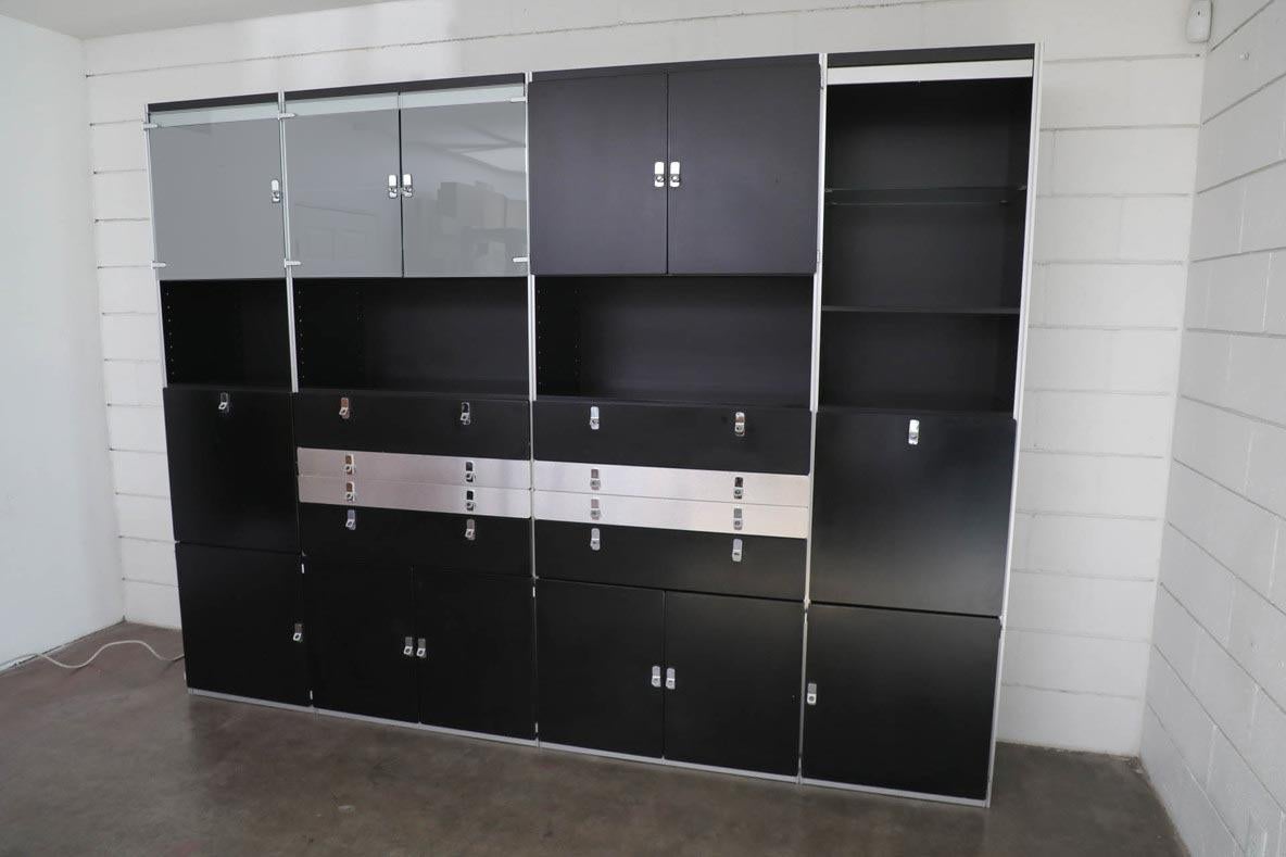 Beautiful Swedish modern design wall unit in black, glass, and aluminum with chrome accents. This impressive piece has 4 