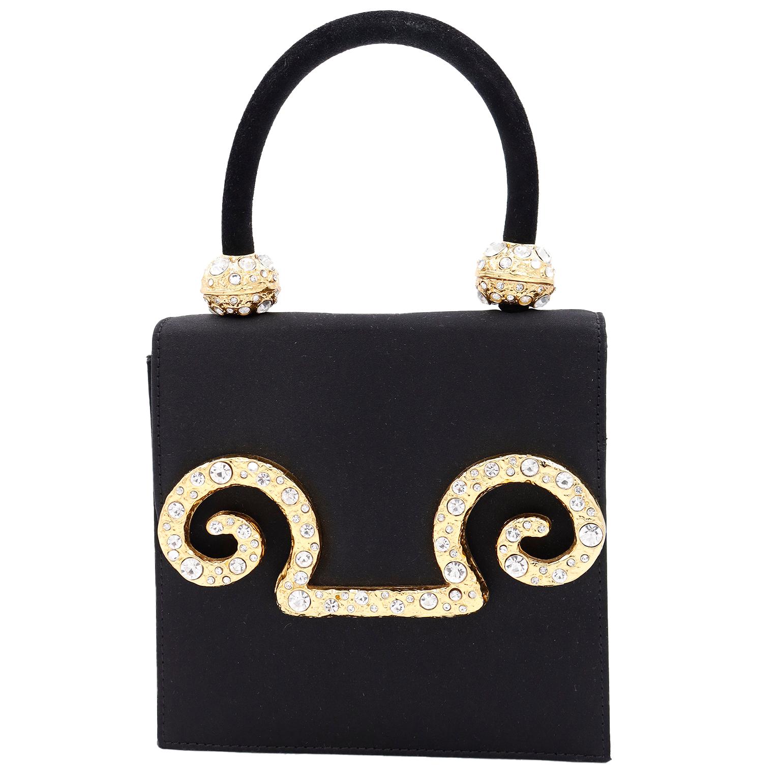 Edouard Rambaud jewelry and accessories are some of the most unique pieces we have come across and this bag is no exception! This fabulous 1980's Rambaud evening bag is in a luxe black satin, which contrasts nicely with the gold plated hardware and