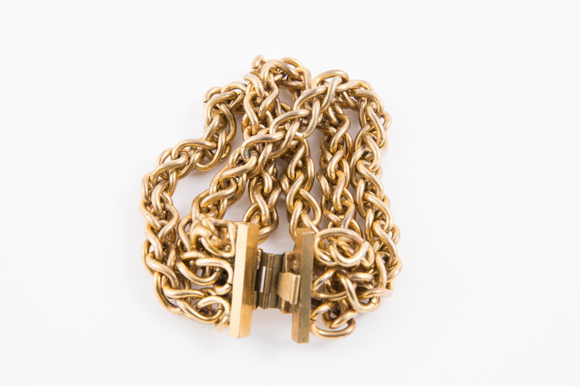 Edouard Rambaud gold tone chain bracelet featuring three rows curb chains, a logo plaque under the bracelet claps. 
Edouard Rambaud is known for the large statement pieces he designed in the 1980s, specifically for runway shows.
In good vintage