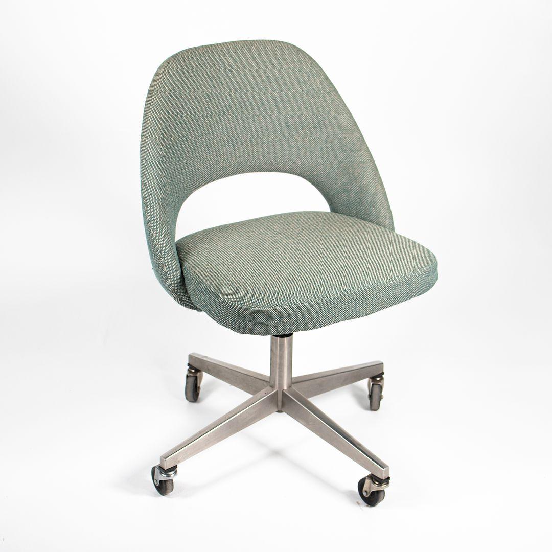 This is a Saarinen armless executive chair, model No. 72 US-BC, designed by Eero Saarinen for Knoll in 1950. This particular example retains its 655 Madison Avenue label, signifying it is a 1980s production. It has a brushed stainless steel 4-star