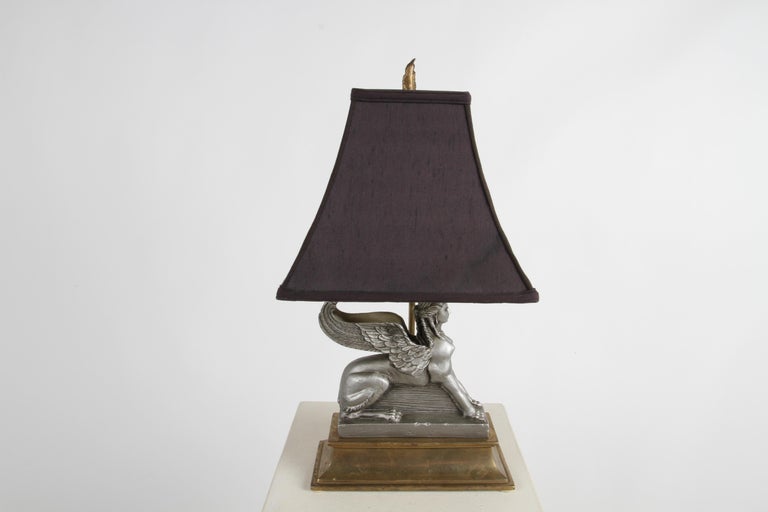 1980s Chapman Lighting Company Egyptian Revival sphinx desk or table lamp. A gray composite sphinx sits atop and heavy brass monument form base. Comes with original shade and final, inline switch, in working condition. Measures: 21.5 