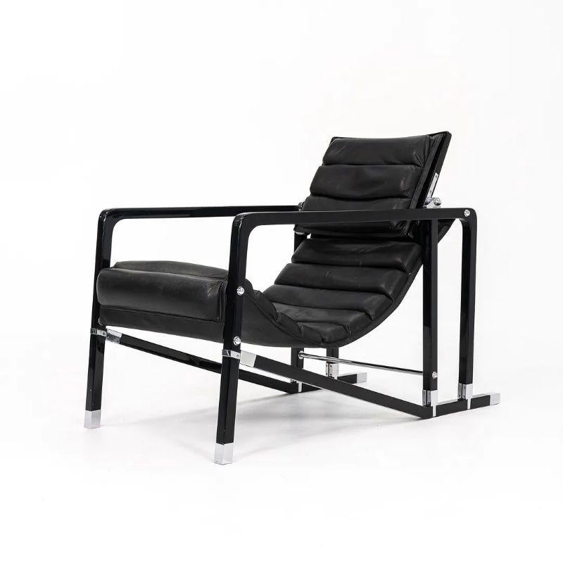 This is a Transat lounge chair, originally designed by Eileen Gray in 1927. This example was produced by French company ECART International in the 1980s. The design features a black lacquered-beech wood frame, and has a black leather seat. The feet