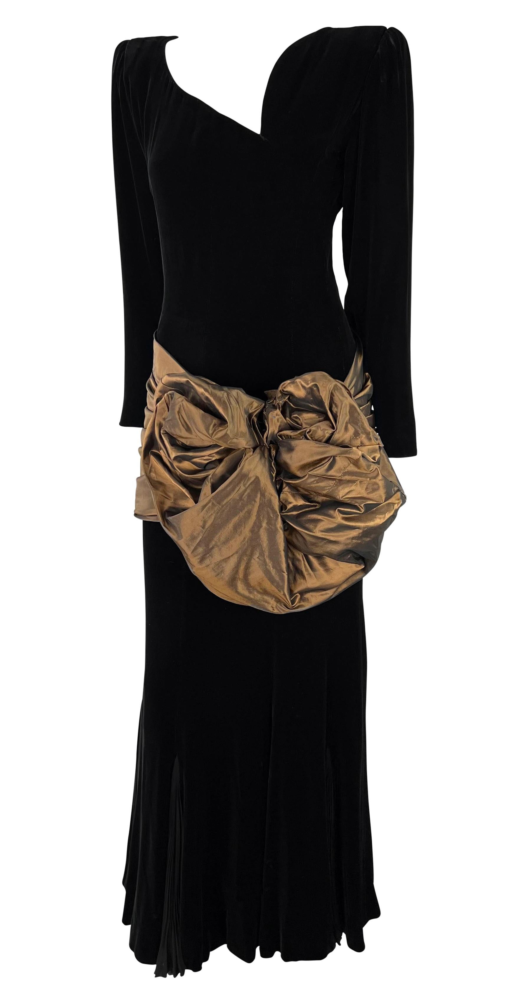 This gorgeous black velvet Emanuel Ungaro haute couture gown was entirely made by hand. From the 1980s, this fabulous custom floor length gown is constructed entirely of soft black velvet. The dress features an asymmetric v-neckline, shoulder pads,