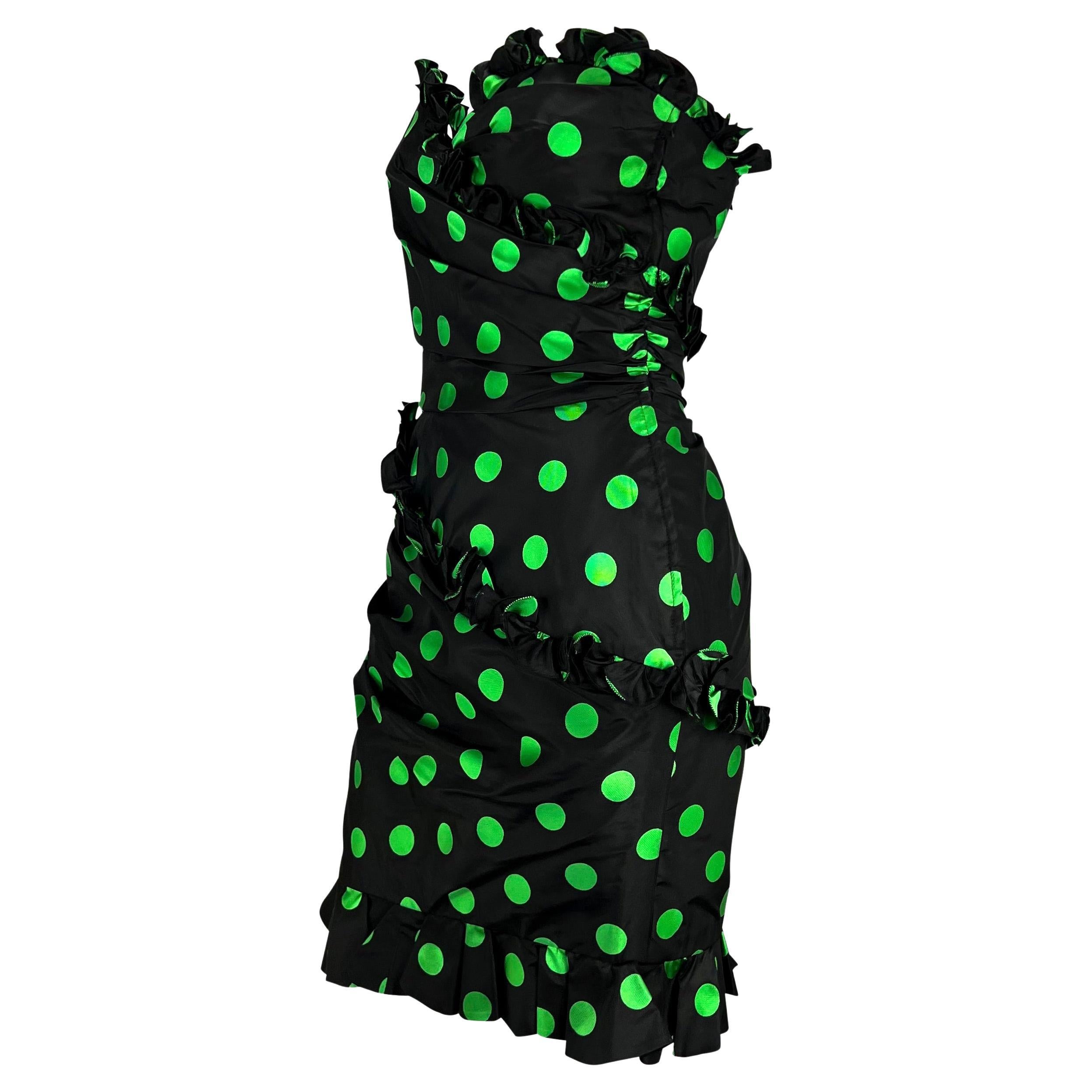 TheRealList presents: an incredible black and green polka dot Emanuel Ungaro dress. From the 1980s, this strapless dress is covered in bright green dots and is wrapped in ruffles. Fabulous and camp, this vintage dress features an 80s look with a