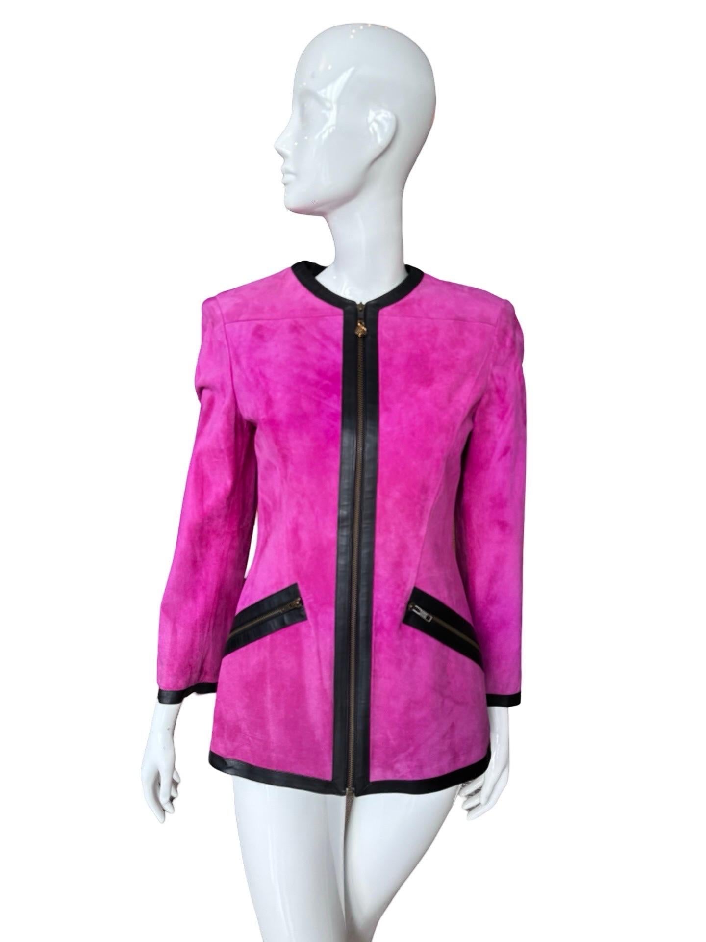 Perfect condition 1980s Ungaro pink fuchsia suede jacket which falls to the hips.  Fitted zip up style with black leather detailing around the collar and down the front zipper and front pockets.  The zippers are in a brass colored metal and there is