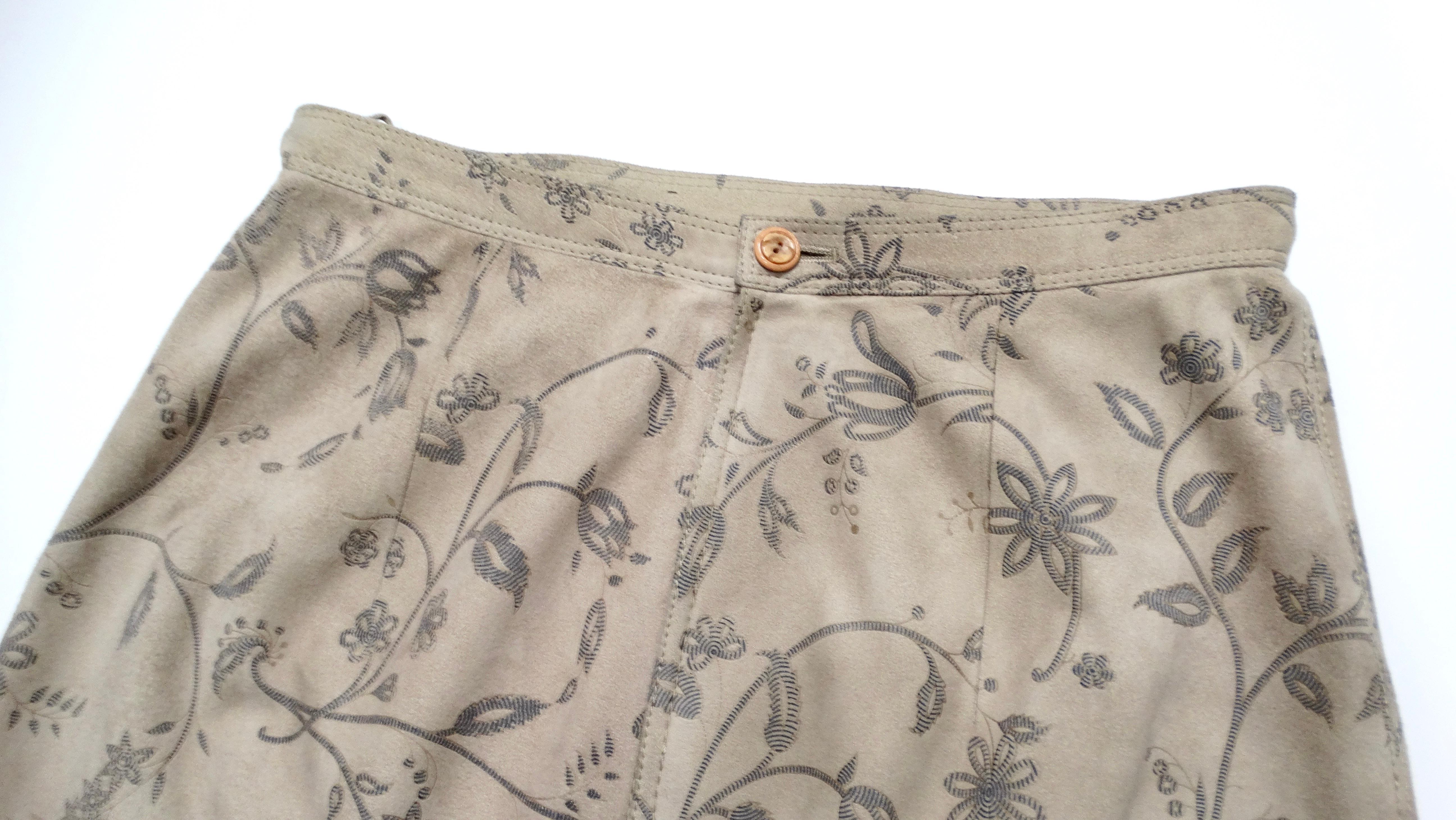 Step back into the vibrant 1980s with this stunning Emanuel Ungaro tan suede floral print skirt, a perfect representation of the designer's bold and sophisticated style. Celebrated for his innovative textiles and fearless patterns, Ungaro has