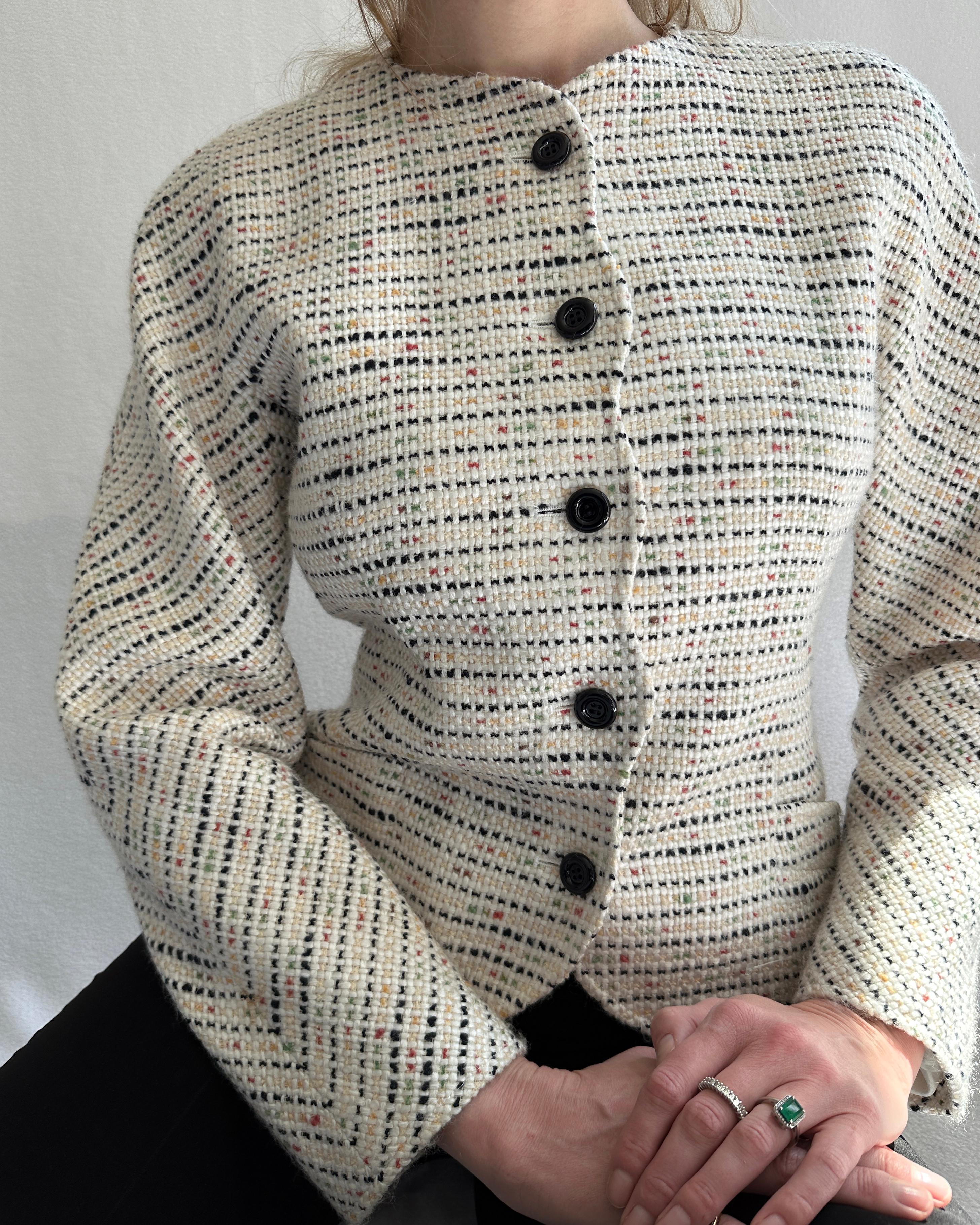 VERY BREEZY presents: It's giving vintage Chanel! Made by Emanuel Unngaro for his Parallele ready-to-wear label in the 1980s, this chic and ladylike jacket features a classic bouclé fabrication, with unexpected whimsical details. Note the squiggle