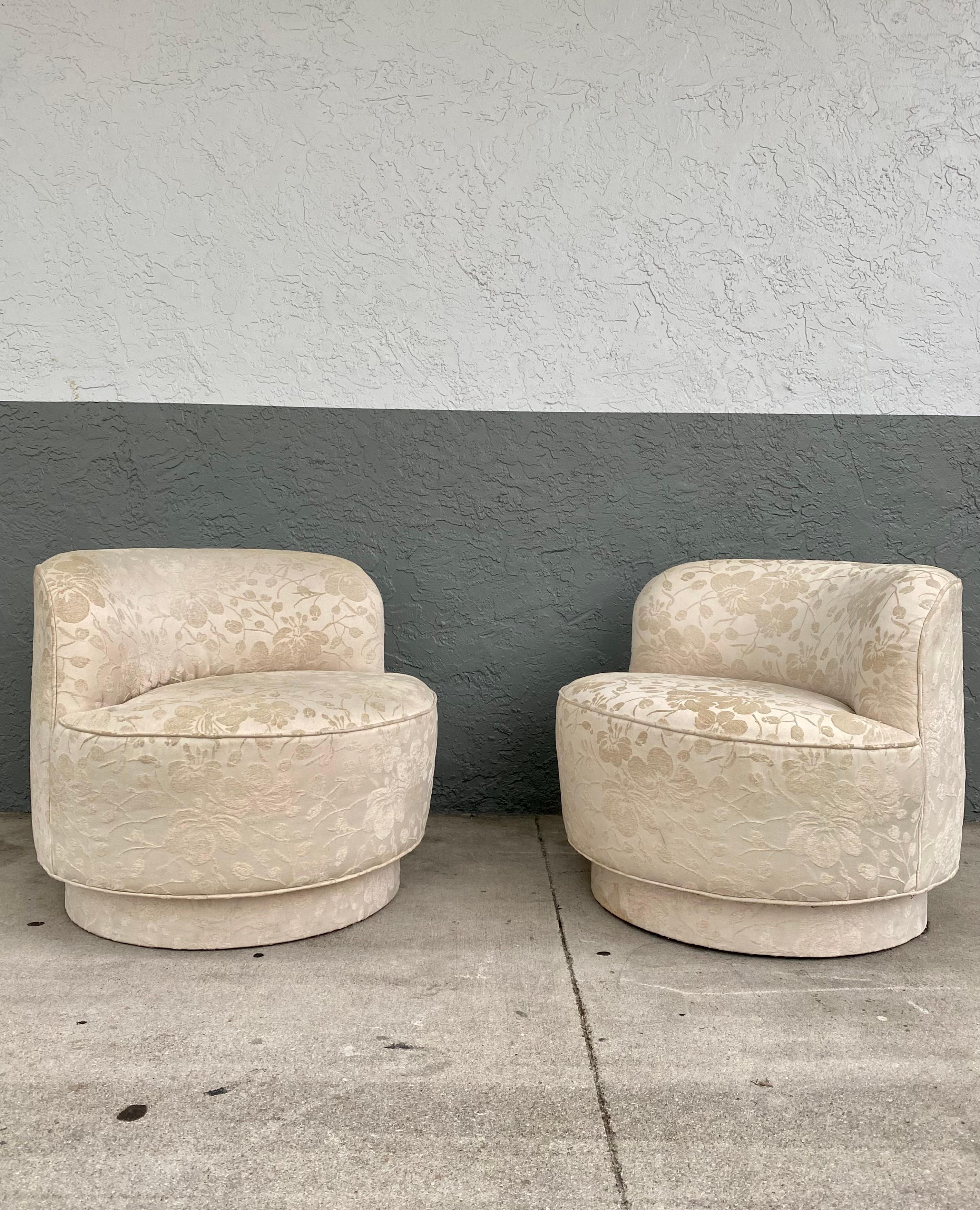 These extremely rare and stylish beige embroidered Floral velvet upholstered swivel chairs are packed with personality! Outstanding design is exhibited throughout. Their beautiful and sculptural shape are in the style of Kagan. The chairs feature a