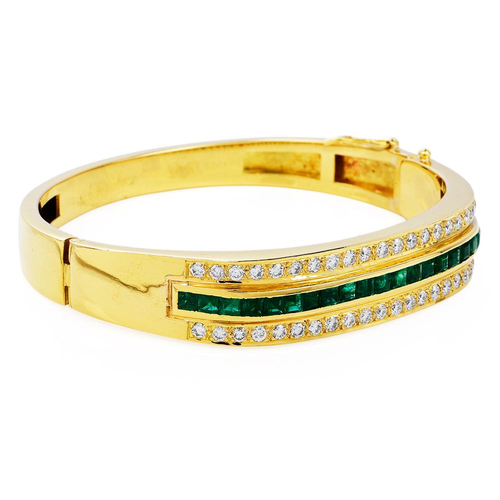 This Vintage 1980s Emerald & Diamond Bangle Bracelet with an approximate total weight of 84.6 grams is crafted in 18k yellow.

 Featuring (21) Genuine Vibrant Green Colombian square cut Emeralds, channel set, weighing 4.00carats

Complimented by