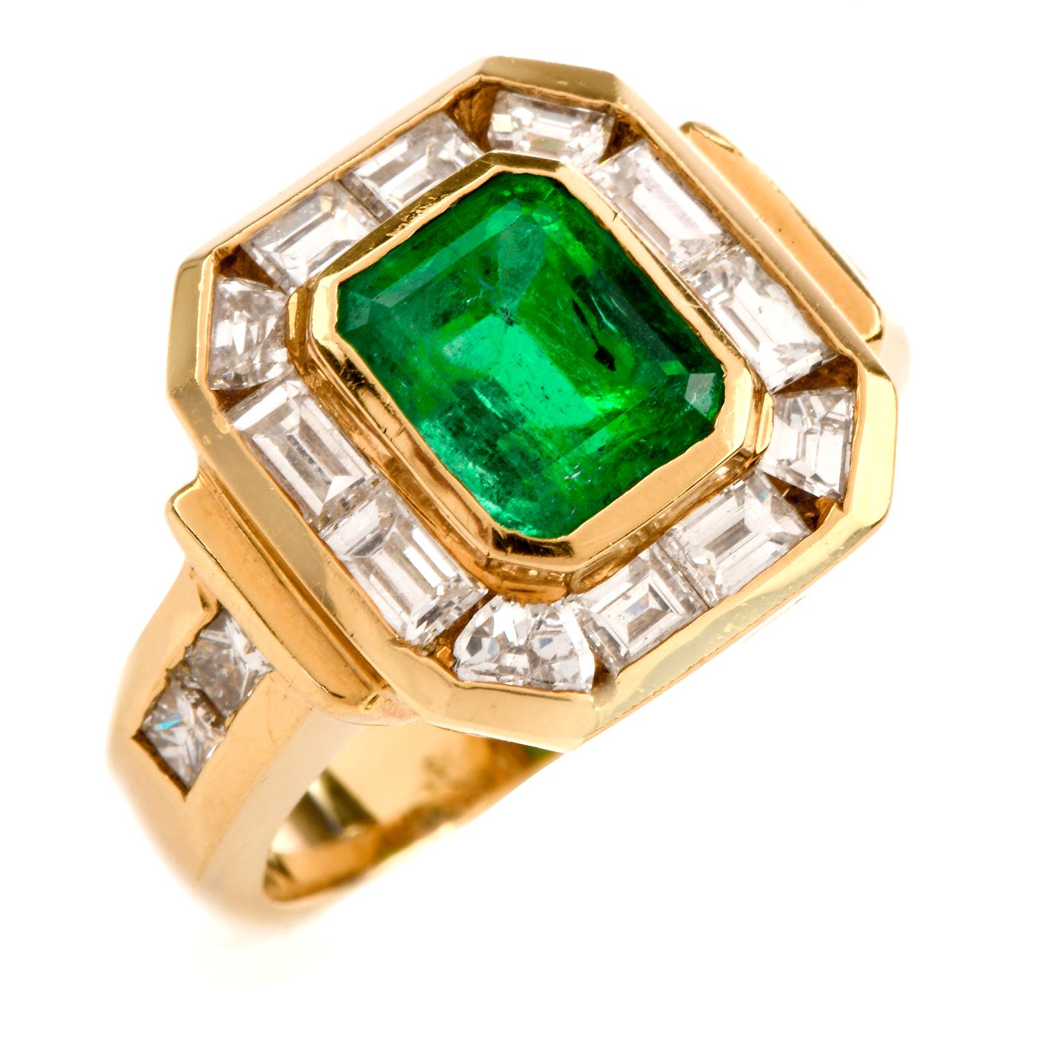 This 1980's estate Colombian emerald and diamond ring is crafted in solid 18-karat yellow gold, weighing 8.7 grams and measuring 14mm x 6mm high. Centered with on bezel-set, emerald-cut genuine emerald, weighing approximately 2.00 carats. Contrasted