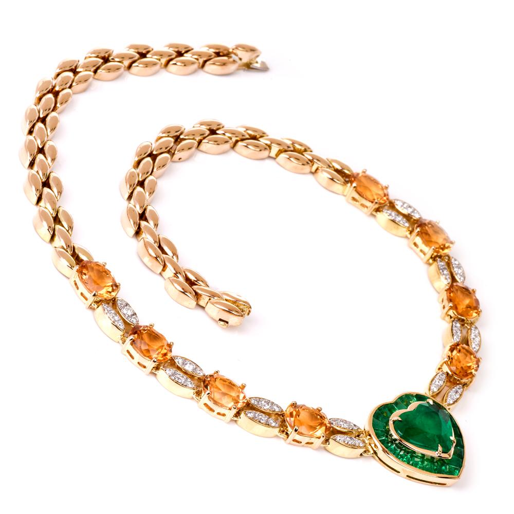 This estate emerald heart choker necklace with diamond and citrine is crafted in 18karat yellow gold. Showcasing a prominent genuine emerald double heart pendant center emerald approx. 3.91 carats set on prongs. Surrounded by approx. 25 tapered-cut