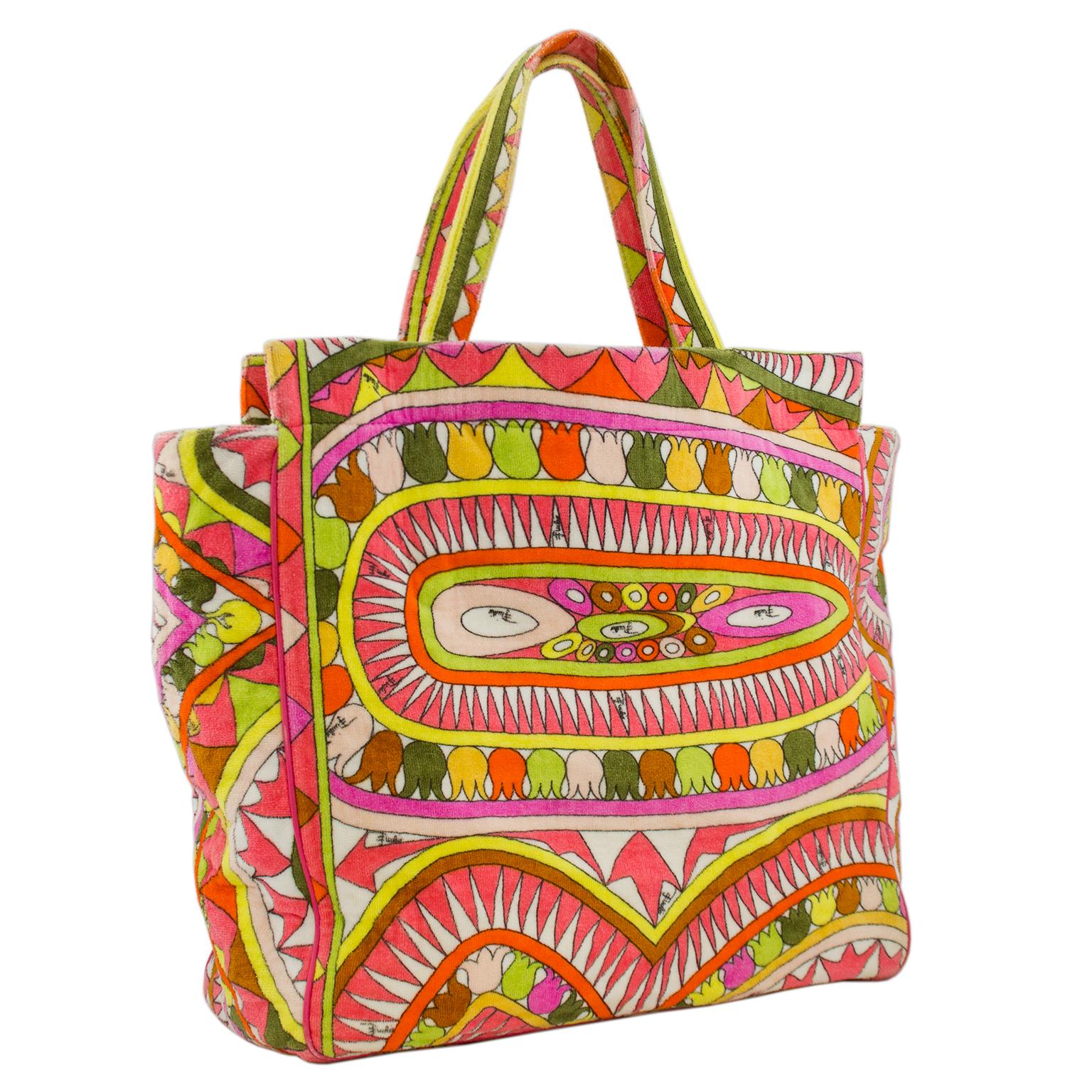 Perfect for the beach or pool, this Pucci tote bag and towel combo is a fashionista's dream. Both pieces feature an all over abstract print in pink, orange, yellow, white and chartreuse. The tote has no top closure and is lined in white vinyl. One