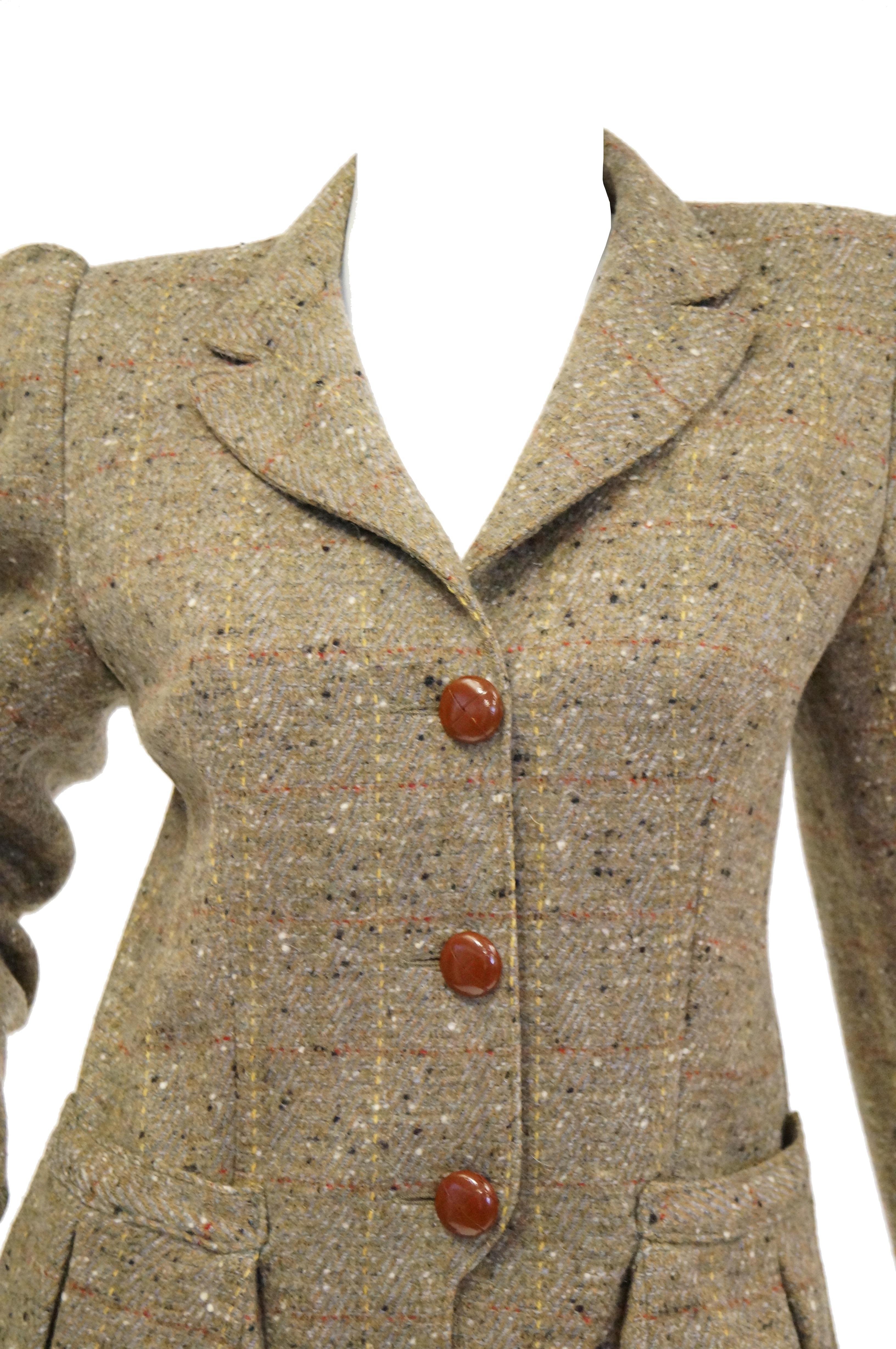 Absolutely delightful Emanuelle Khanh wool blazer with a fantastic 1980s When Harry Met Sally flair! The blazer hits mid hip, has long sleeves with puffed leg of mutton - like shoulders, a high stance with notched lapel. The jacket has a three