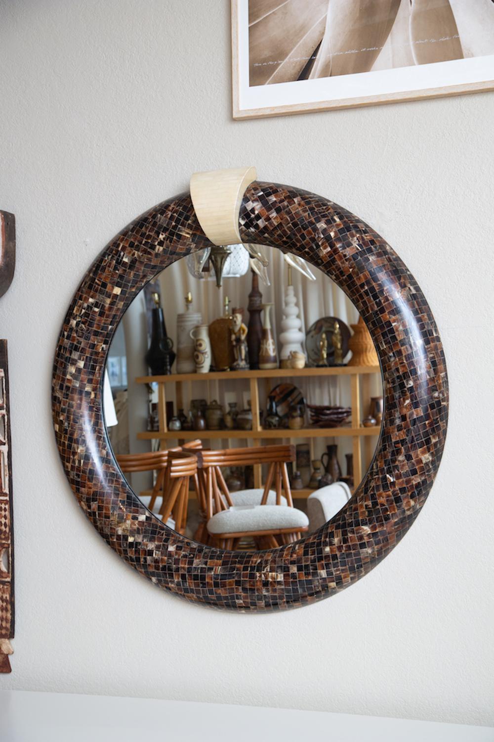 Large statement mirror in tessellated cow horn with Bone keystone tile inlay.
This is a striking addition to any room.