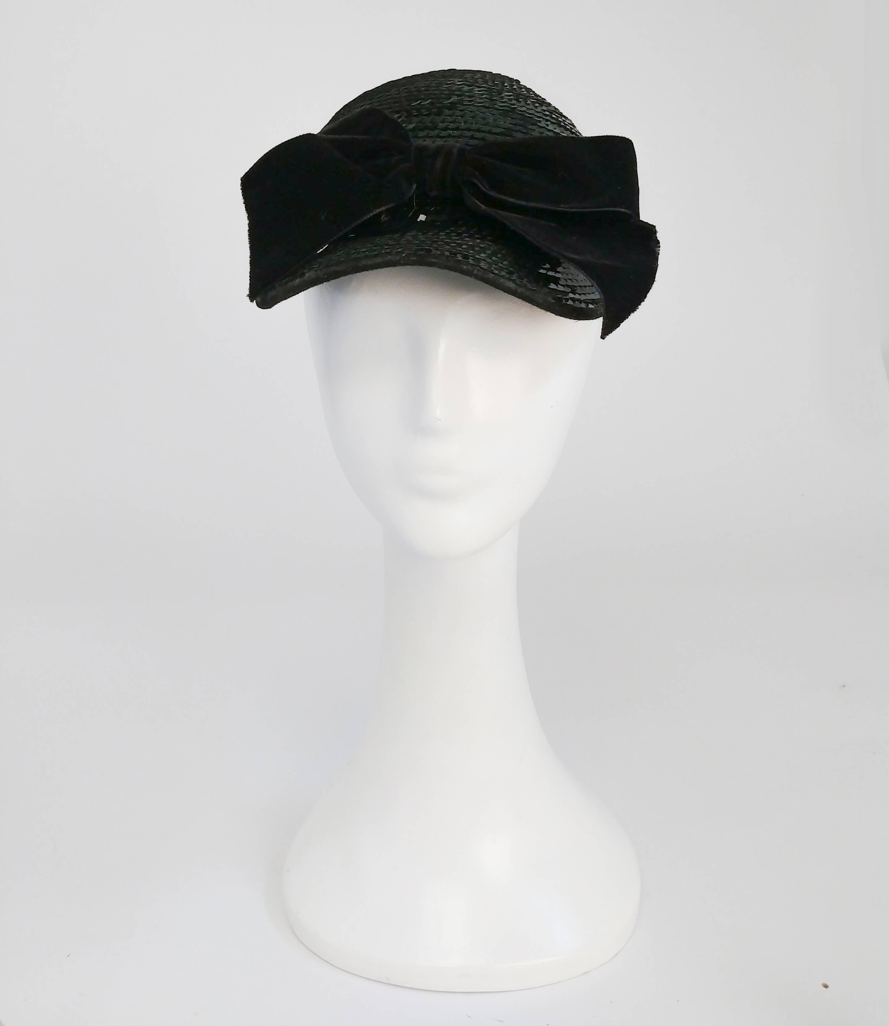 1980s Eric Javits Black Sequin Cap w/ Velvet Bow. Black cap encrusted in scequin and garnished with a velvet bow. 21 to 22 inch circumference