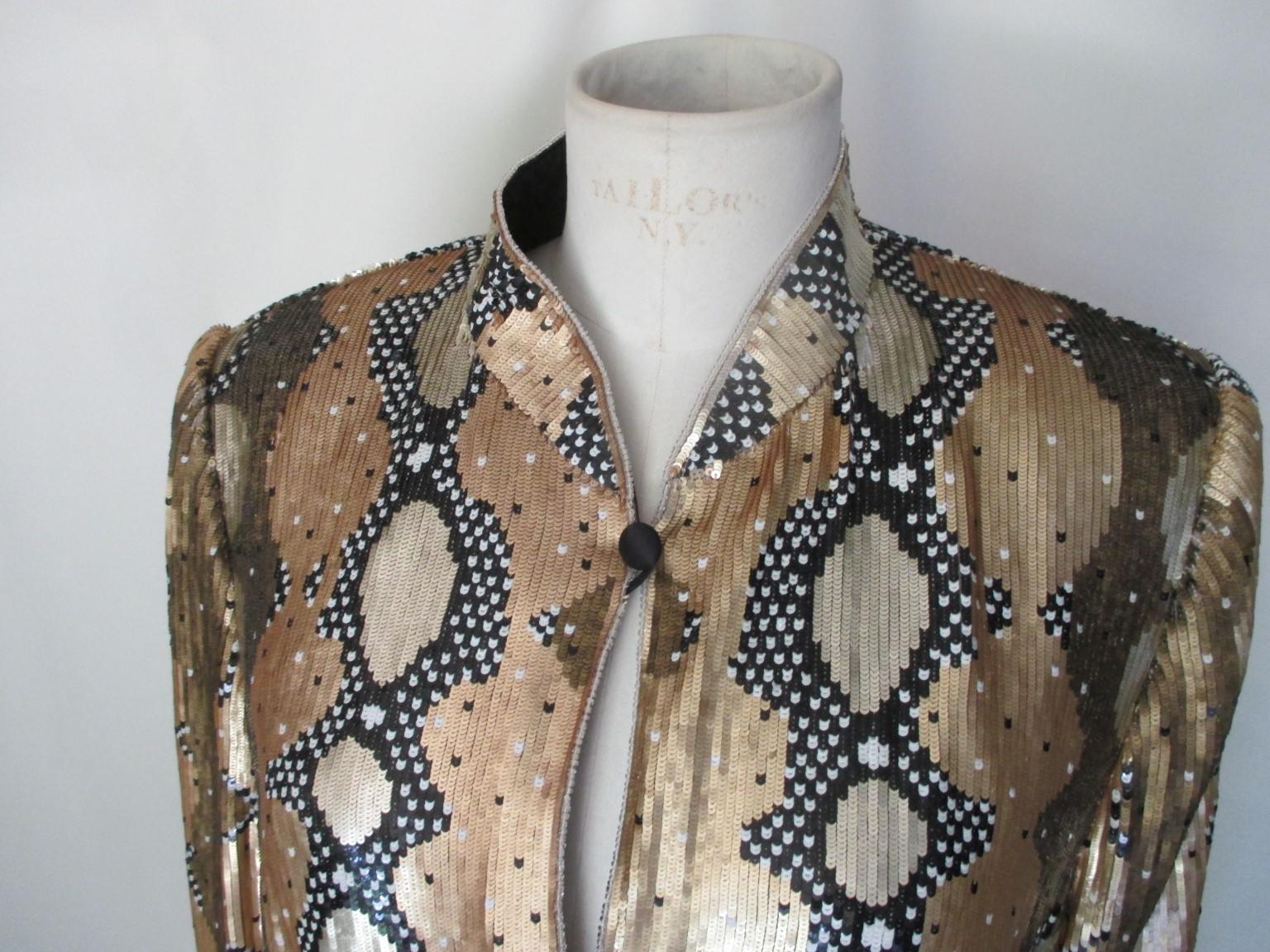 Rare Escada Couture gold/silver /black/bronze fully sequins ladies evening/party jacket.

We offer more exclusive items, view our frontstore.

Details:
At front 7 black buttons 
Fully lined
Vintage 1980's
Can be worn on jeans or at events
Pre loved