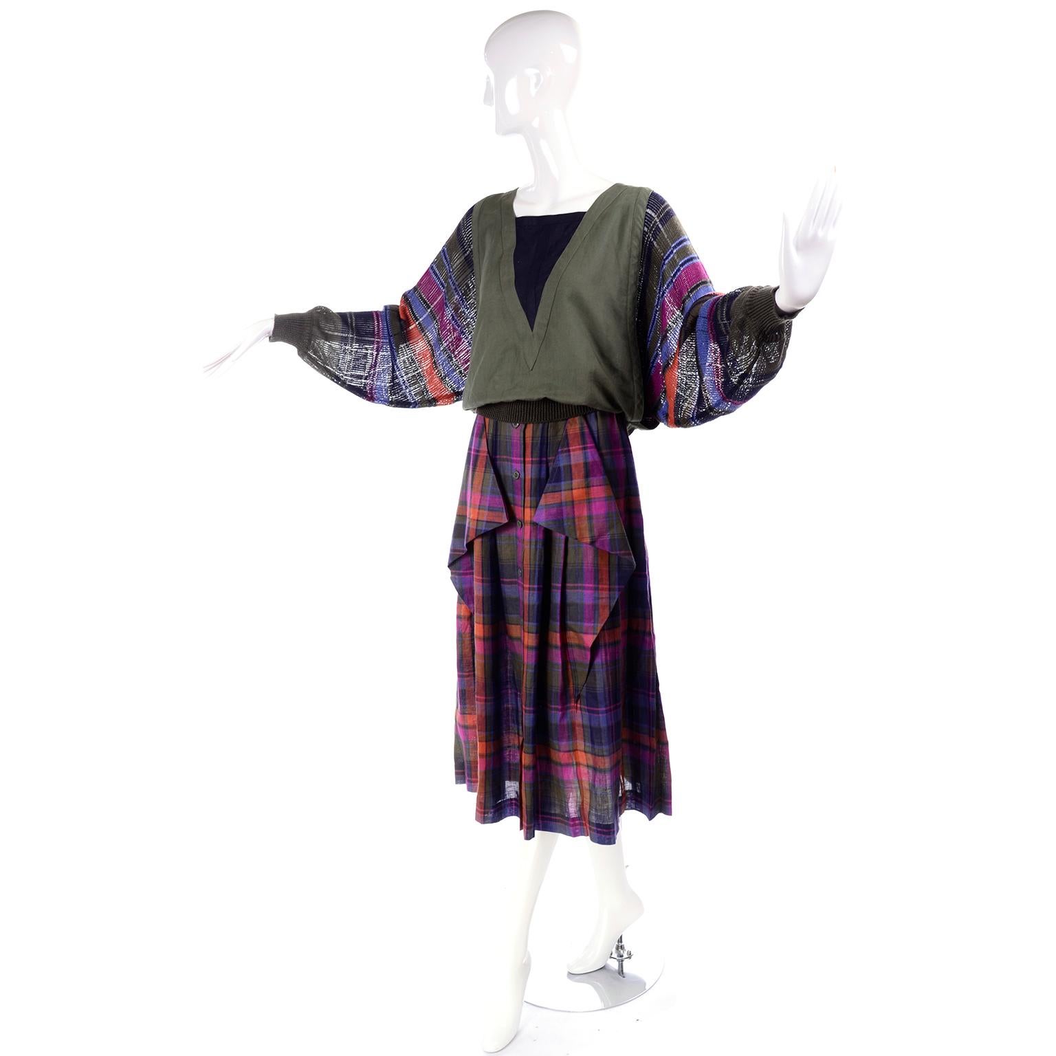 This is a beautiful ensemble from the 1980's designed by Margaretha Ley for Escada. The outfit has a pleated midi length skirt that buttons down the front. It is made of linen in an olive green, pink, blue and orange plaid print. It has two
