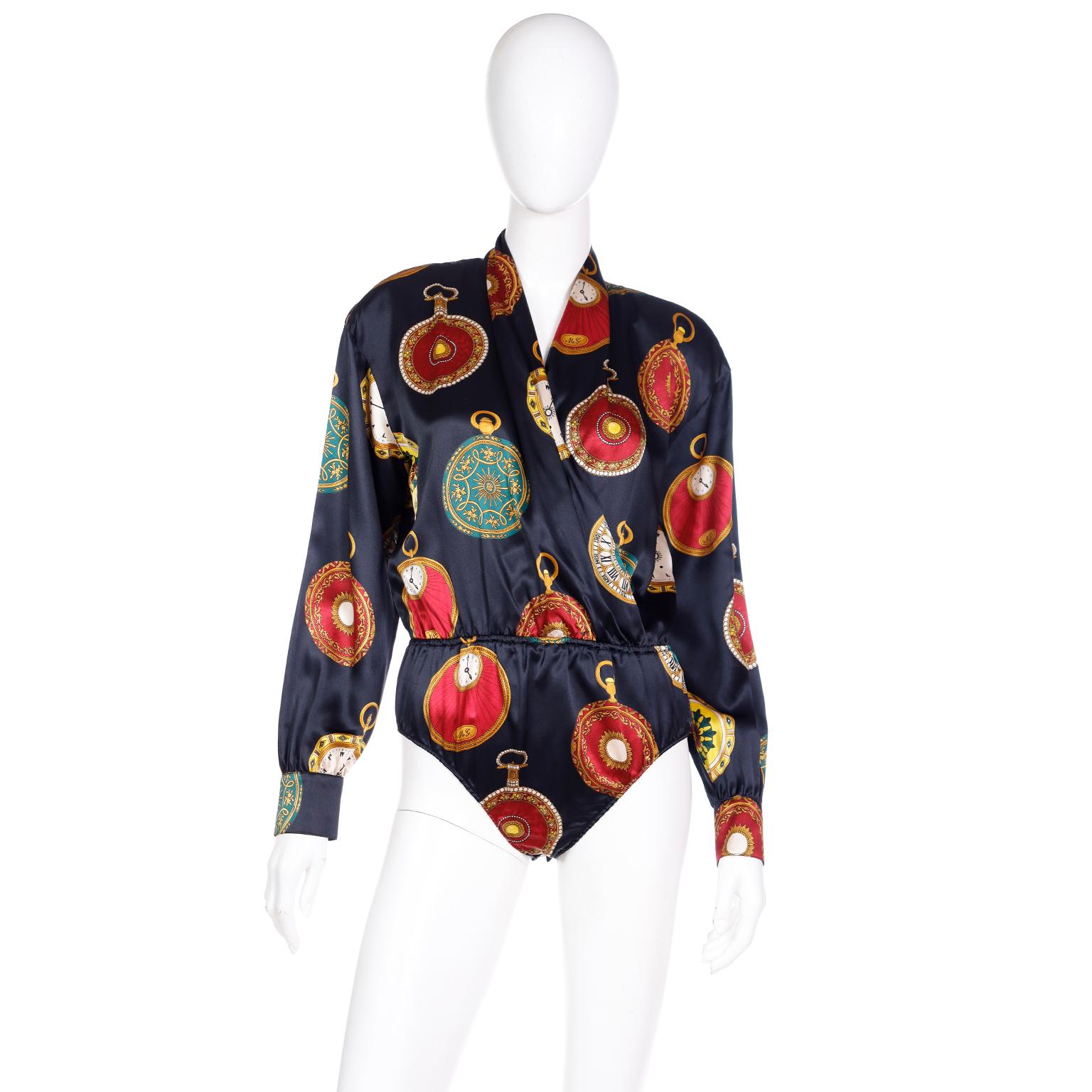 We love a vintage Escada novelty print and this pocket watch print is so fabulous! This luxe silk bodysuit style blouse is black with multi colored pocket watches featuring decorative cases,clock faces, and ML; Margaretha Ley's initials. Even the