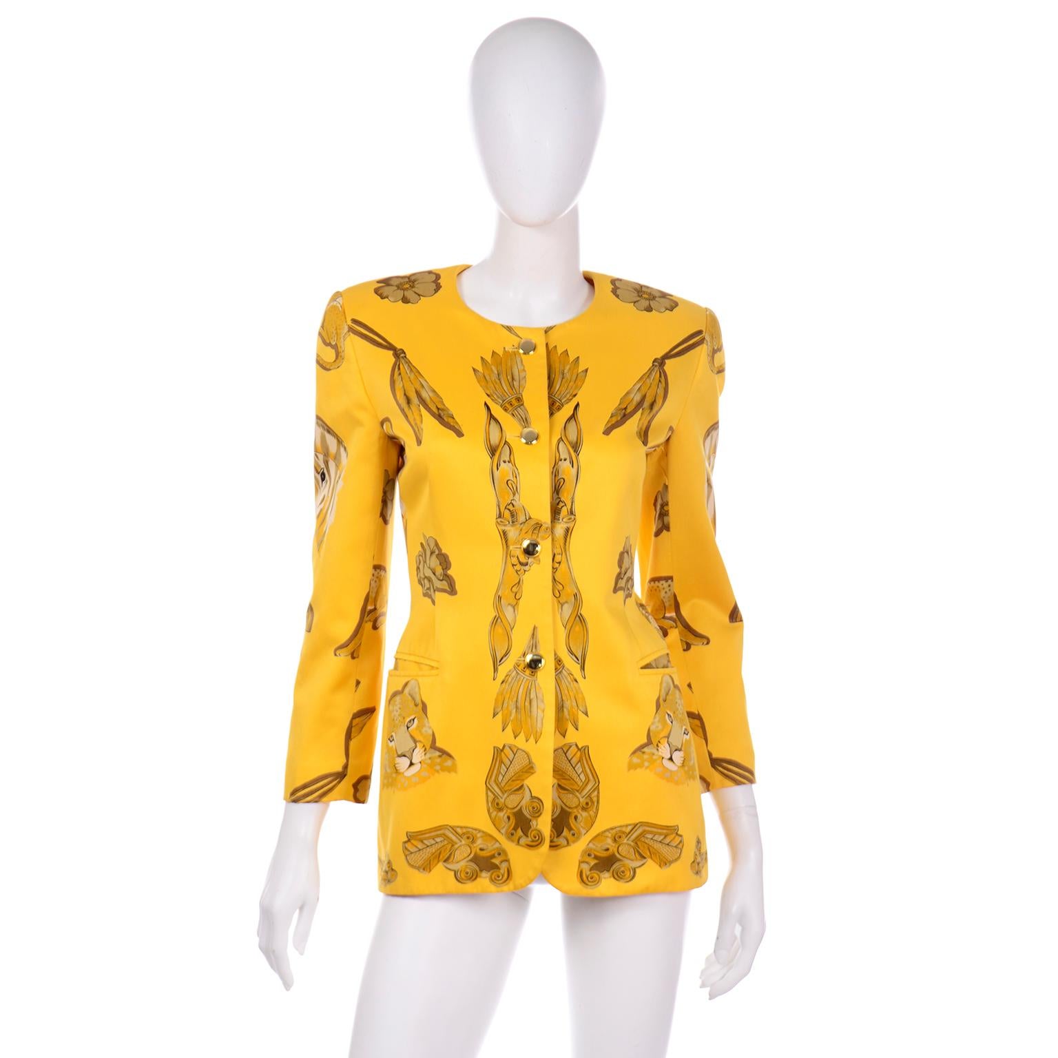 This is a phenomenal Escada polished cotton novelty printed jacket in a gorgeous marigold yellow. We love Margaretha Ley's prints and this one features cheetahs, giraffes, flowers, and various Aztec figures. This jacket has a long line silhouette