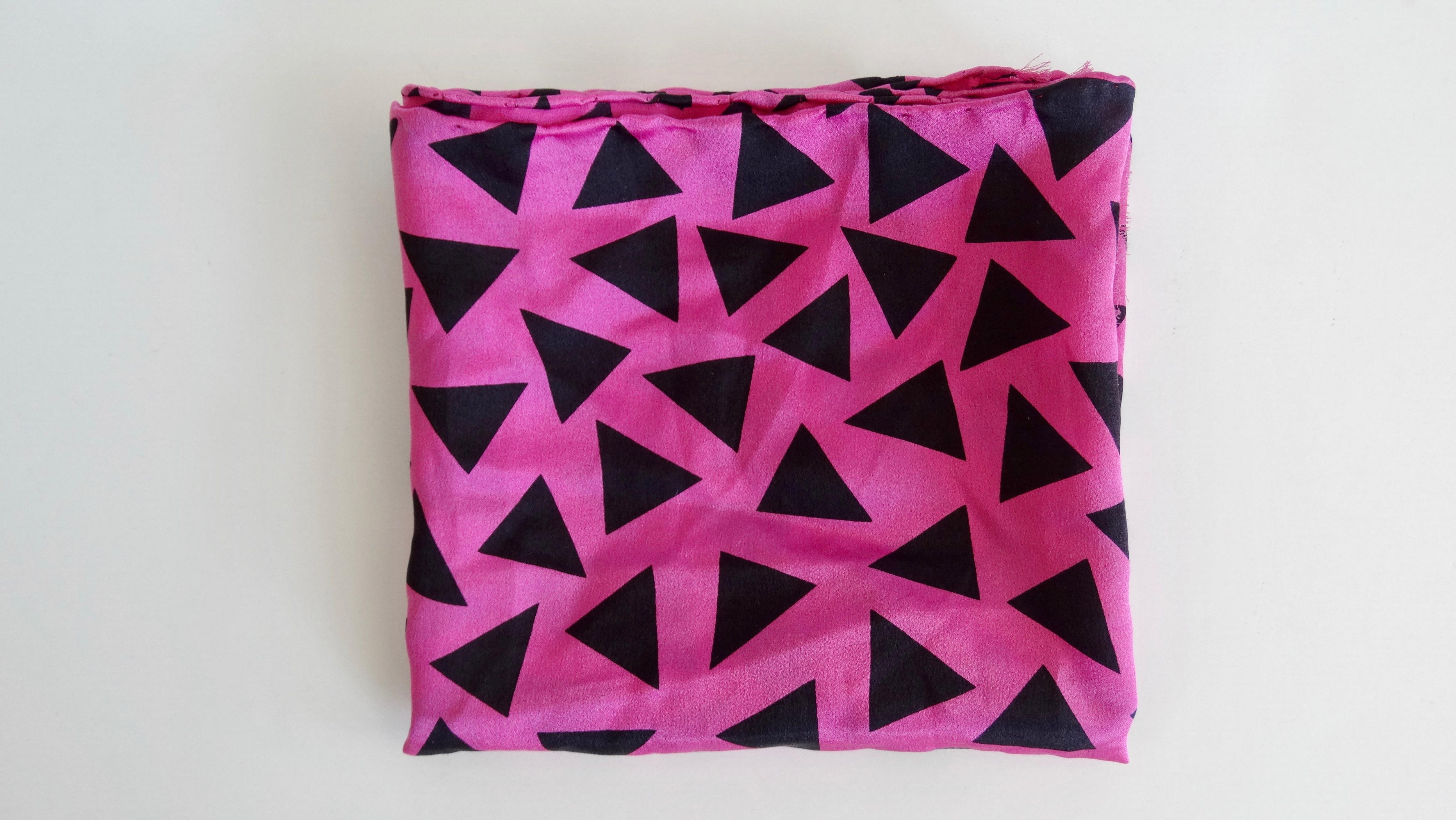 Elevate your look with this amazing Memphis Milano scarf! Circa 1980s, this Silk scarf features a geometric design created by Memphis Milano member and creator, Ettore Sottsass. Comprised of multi-directional black triangles against a bright fuchsia