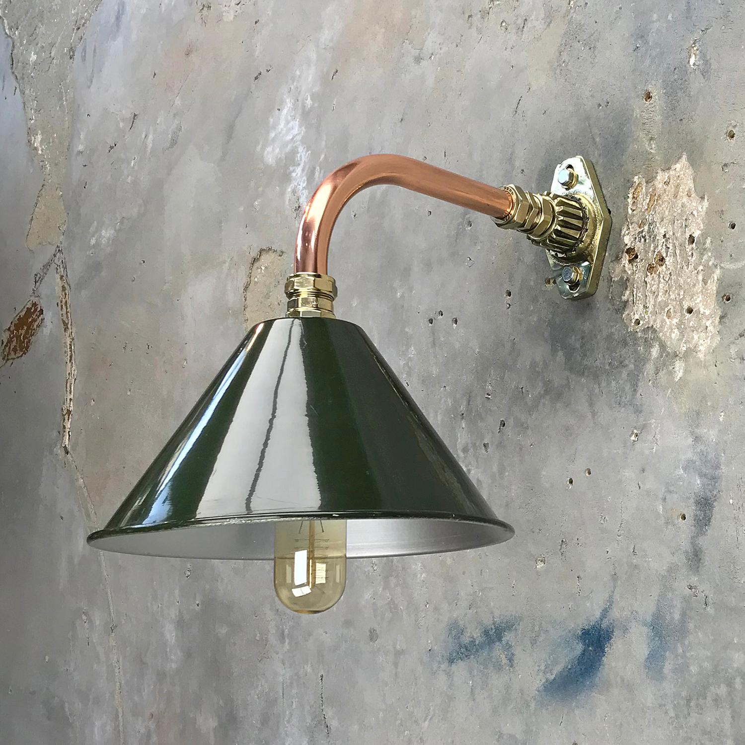 Ex British army festoon lamp shade fitted to a copper and brass cantilever fitting.

At Loomlight we have fabricated a copper and brass cantilever wall mount and we can offer customised dimensions for the reach of the lamp from the wall, we can