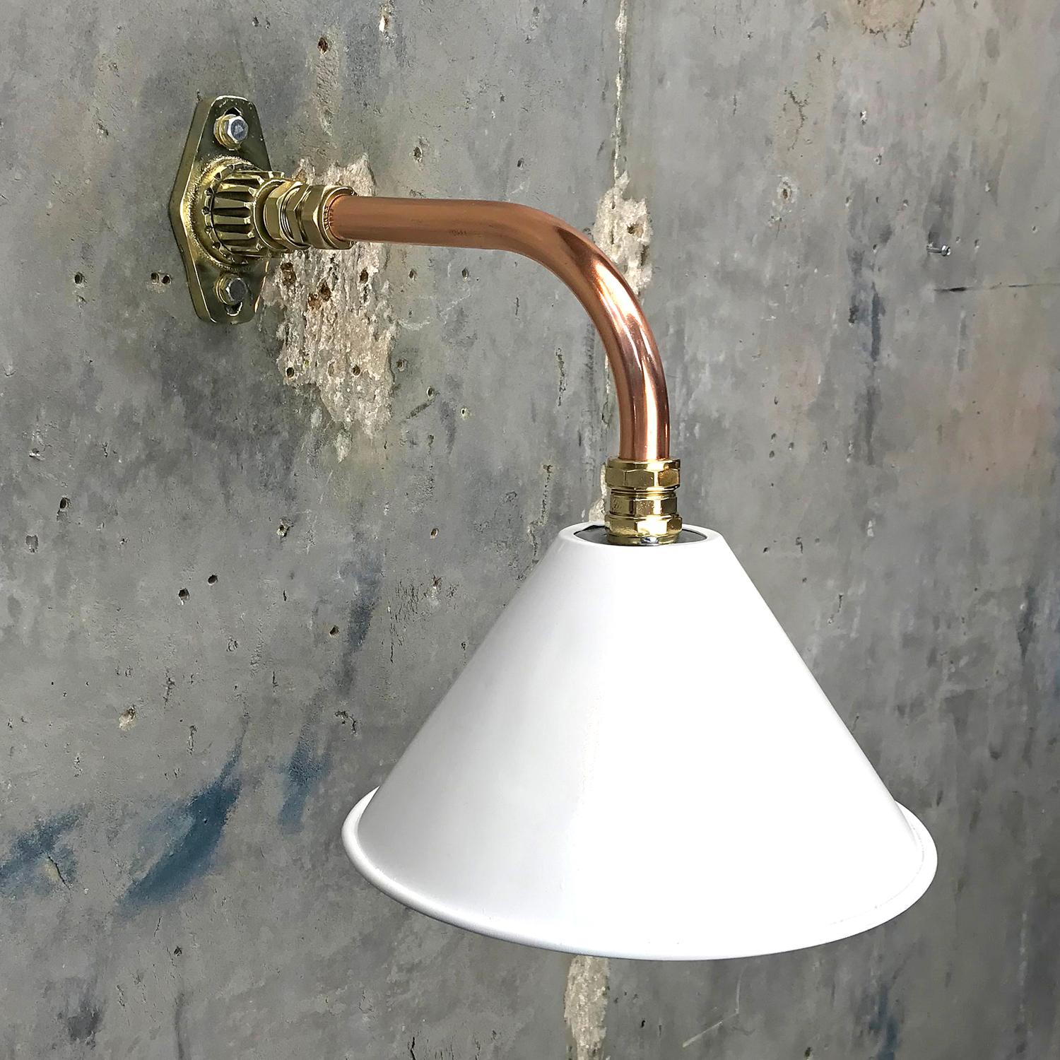Ex British army festoon lamp shade fitted to a copper and brass cantilever fitting.

We have fabricated a copper and brass cantilever wall mount and we can offer customised dimensions for the reach of the lamp from the wall, we can also finish the