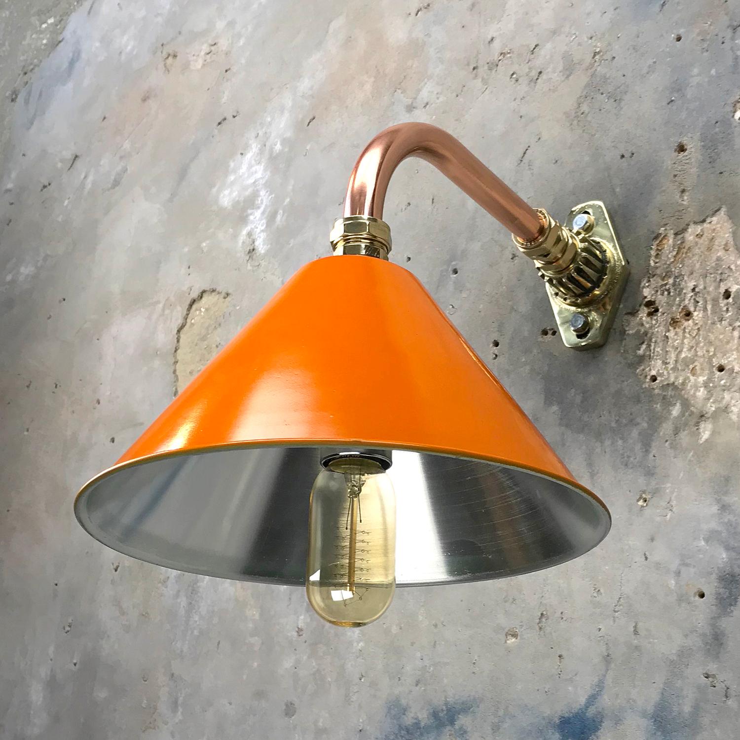 Ex British army festoon lamp shade fitted to a copper and brass cantilever fitting.

At Loomlight we have fabricated a copper and brass cantilever wall mount and we can offer customized dimensions for the reach of the lamp from the wall, we can