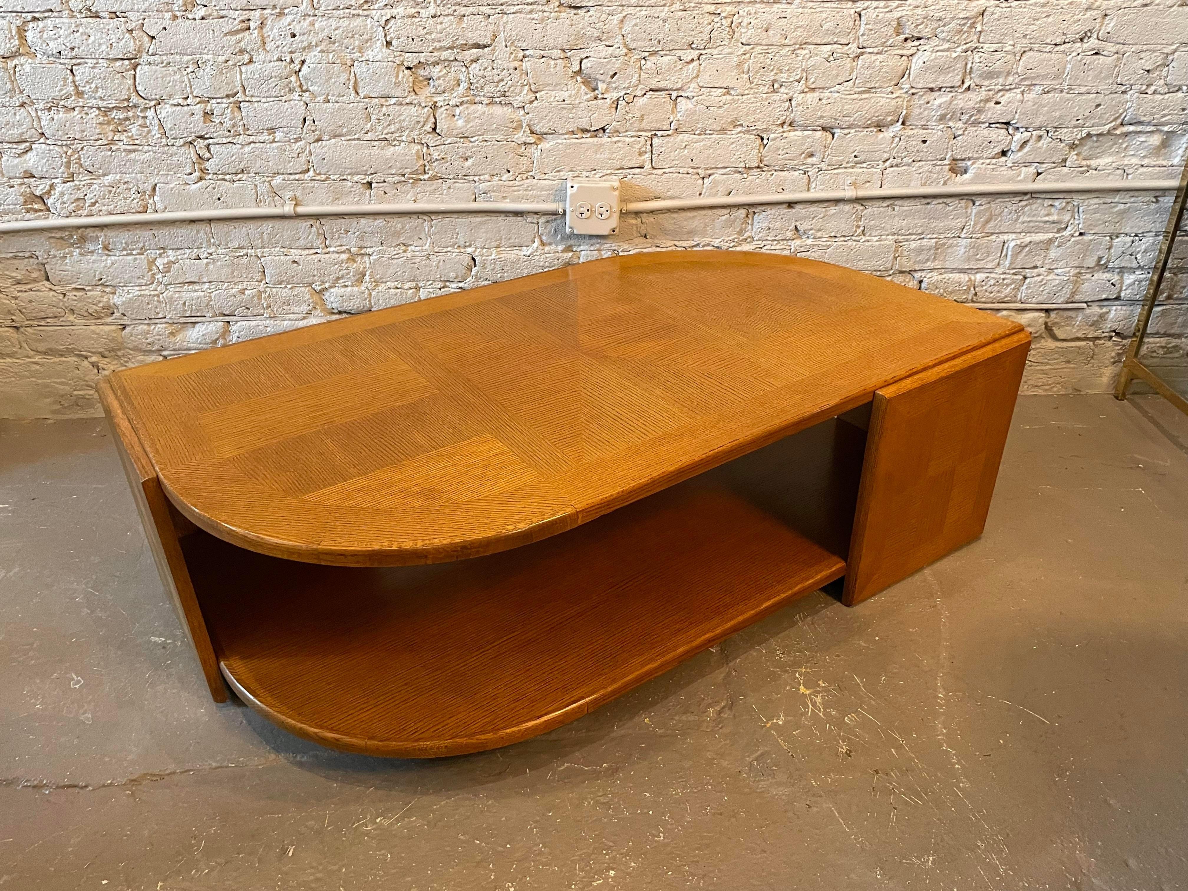 Solid wood eye shaped coffee table with an open shelf to put anything or nothing! The table is on tiny wheels for easy mobility.
 