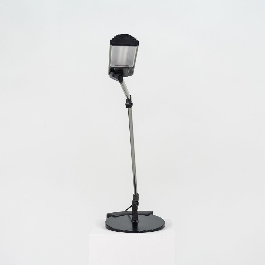 This is a Desk 990 Lamp, originally designed by Ezio Didone in 1983. This particular example Flos acquired from Arteluce and was produced in the 1980s. Atelier International distributed Flos for a number of years in the US. The lamp is comprised of