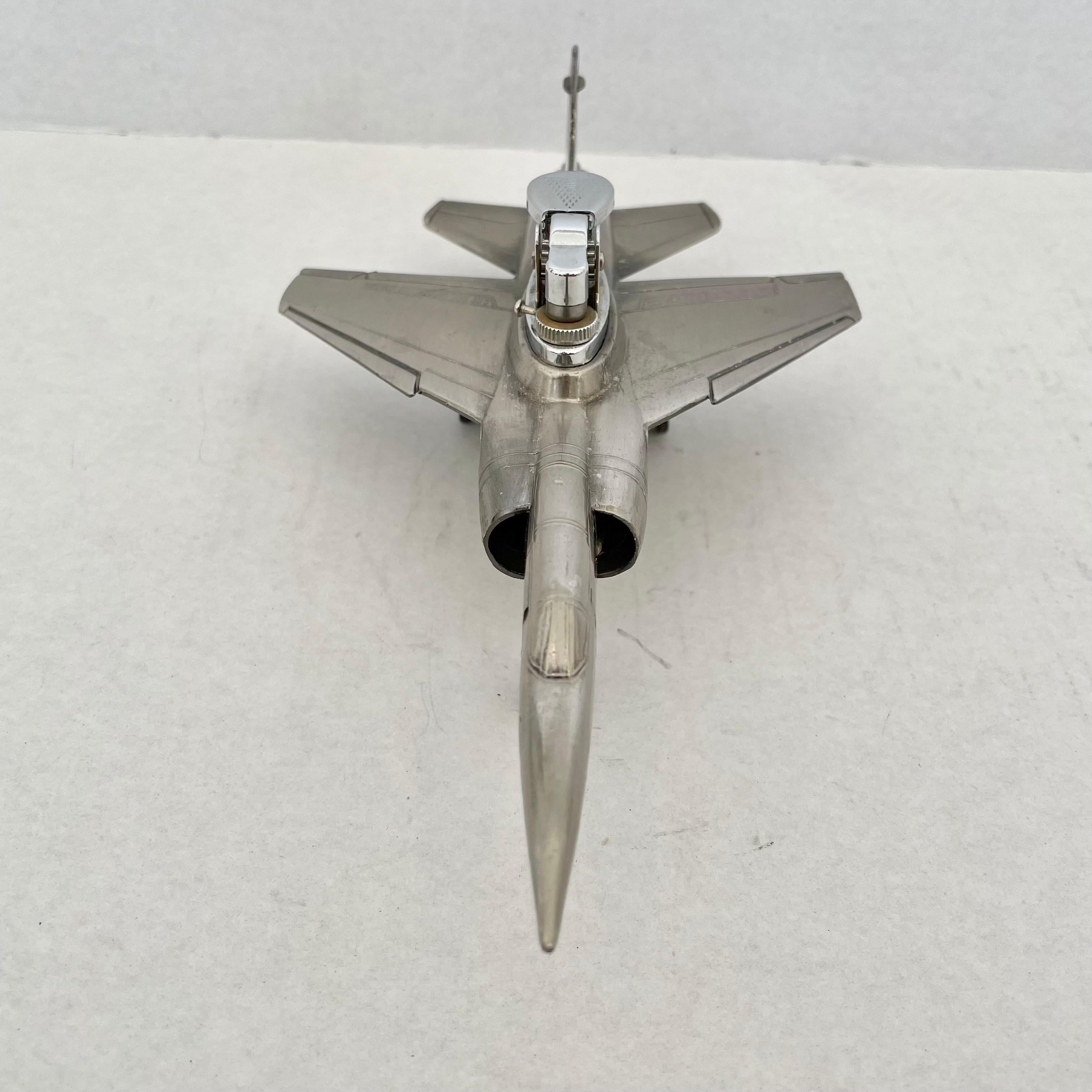 Cool vintage table lighter in the shape of a F1 Mirage fighter jet. Made in Japan, 1980s. This piece has great balance and details. Cool tobacco accessory and conversation piece. Working lighter. Good vintage condition.