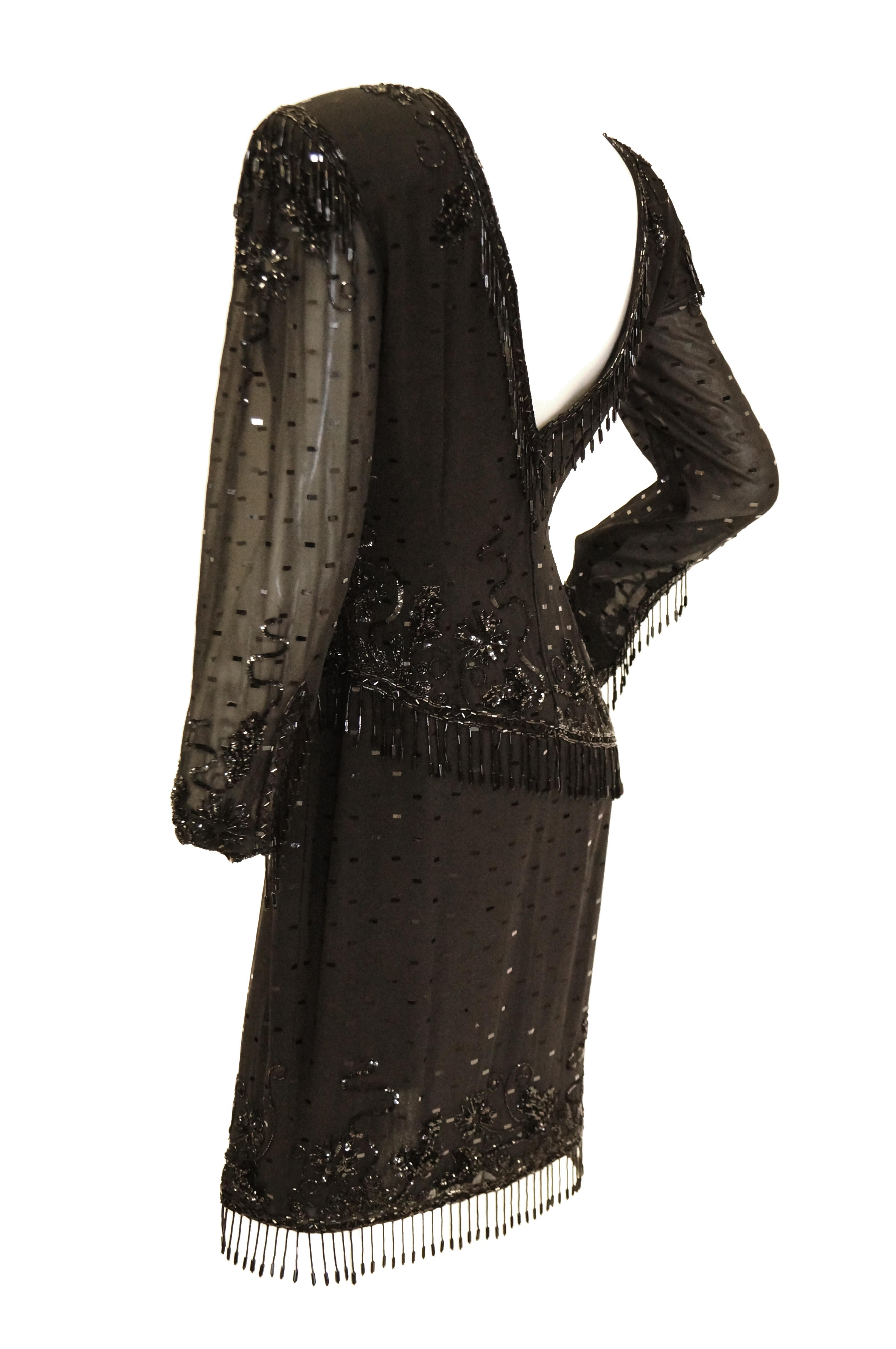 Incredible 1980s - does - 1940s Fabrice black silk cocktail dress! The dress is knee length, with long sleeves and a jewel neckline. The dress has a sheath silhouette, with a sarong - like skirt that harkens back to the Polynesian craze of the