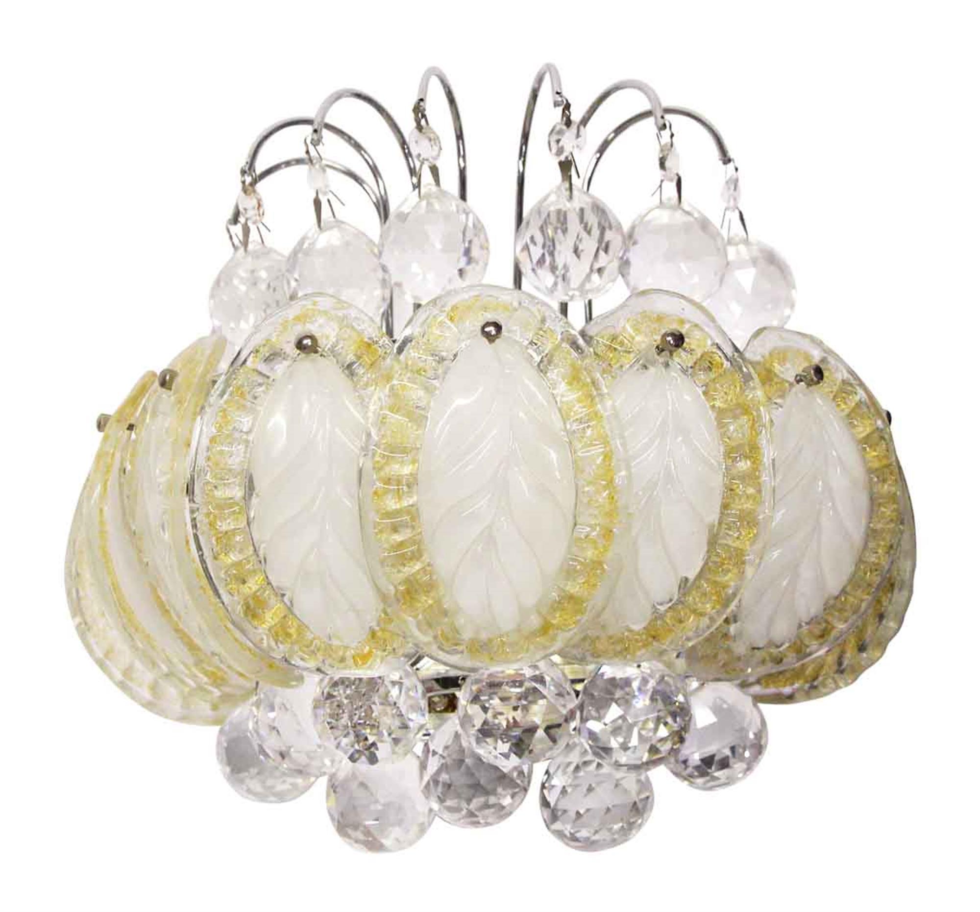 1980s glass leaves and faceted crystal sconce. Matching chandeliers available. Requires three bulbs. Please allow two weeks for rewiring and cleaning. Several available at time of posting. Priced individually. This can be seen at our 302 Bowery