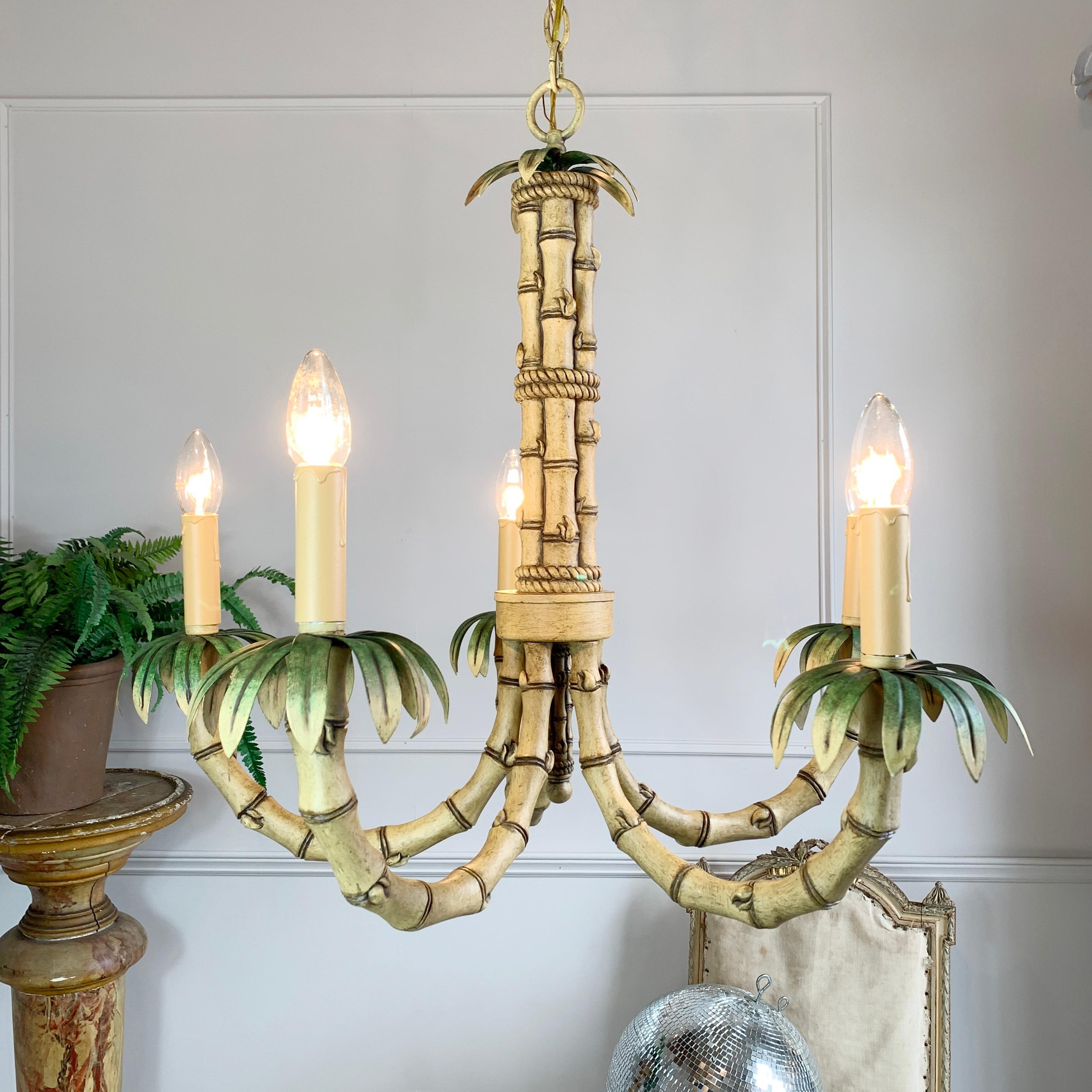 Naturalistic faux bamboo chandelier, created in painted metal to replicate the look of bamboo, this is a heavy and attractive light with 5 lamp holders all adorned with painted leaf decoration. Dates to the 1980’s.

Measures: Height 90cm x width