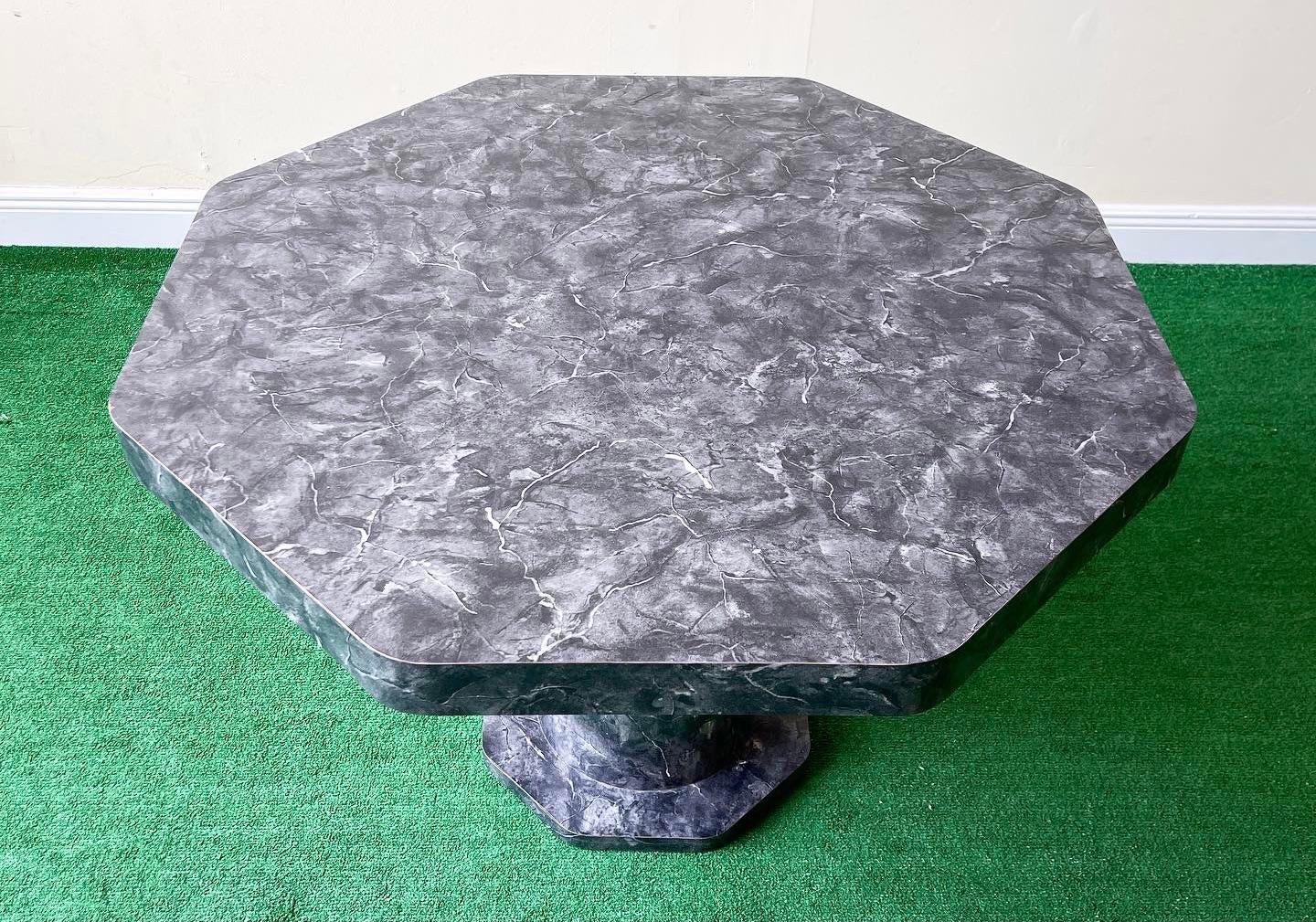 Classic faux marble laminate octagonal dining table. Black grey and white tones fill the surface of the entire table top and pedestal.
 