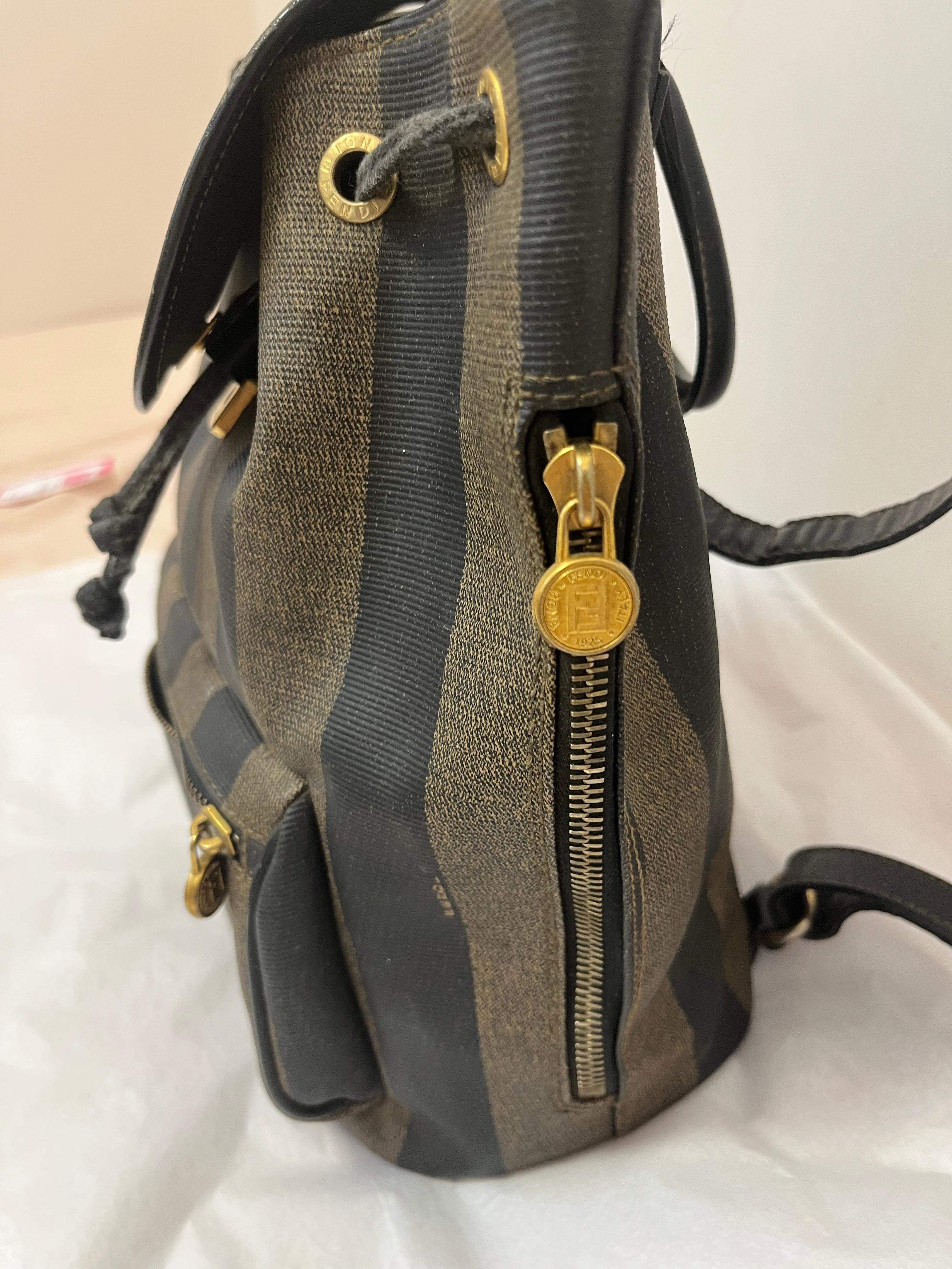 This 1980s Fendi backpack is in wonderful vintage condition, with wear only seen on the leather bucket pull. 
The backpack shoulder straps are adjustable and there is also a top handle.
The wide stripe monagram with the Fendi lettering is iconic for