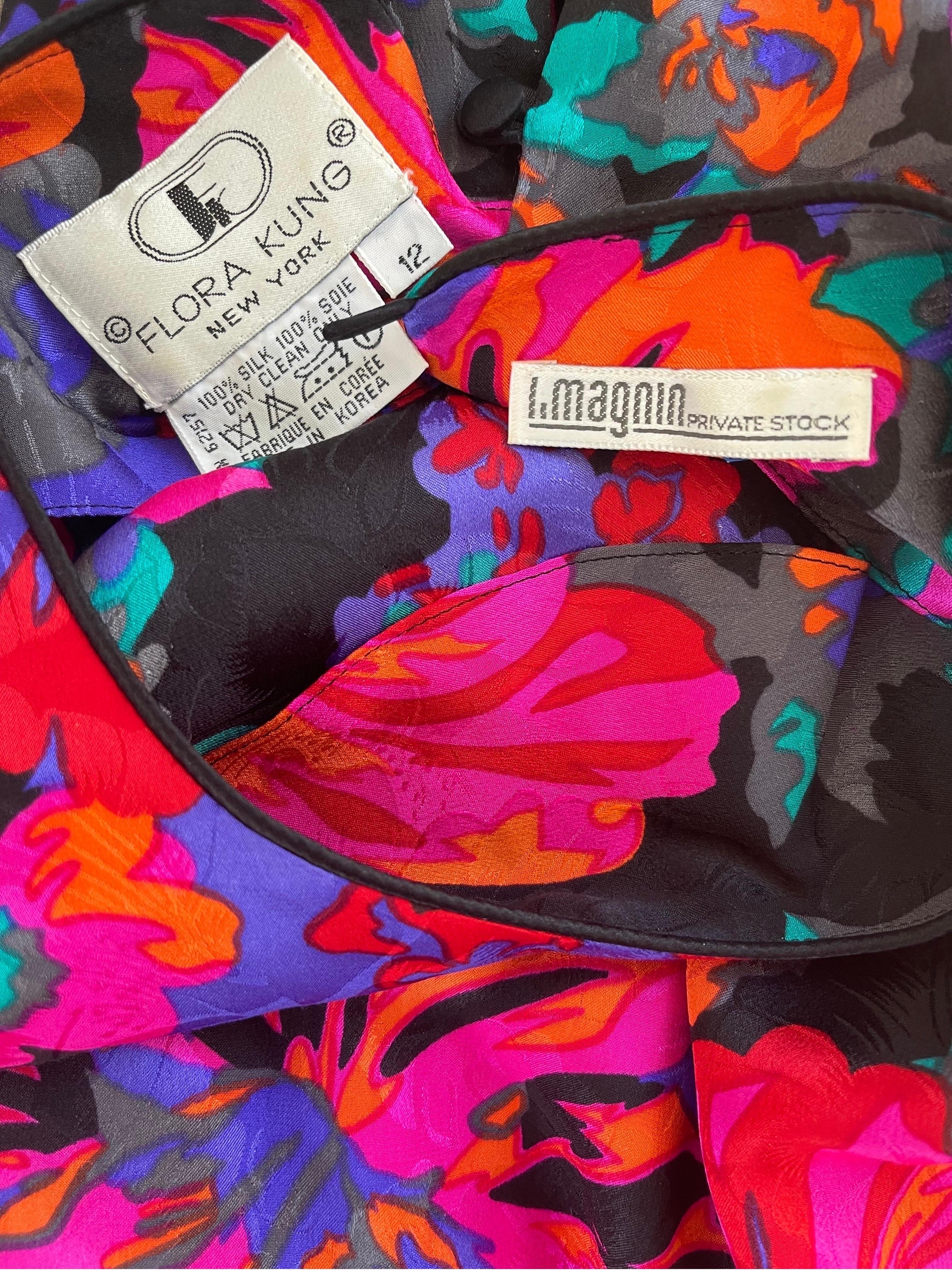 Beautiul vintage 70s FLORA KING for I Magnin Hawaiian print silk blouse ! Vibrant colors of purple, blue, orange, turquoise blue, pink and black throughout. Buttons up the back at neck. 
In great condition
Marked Size 12
Measurements:
40-42 inch