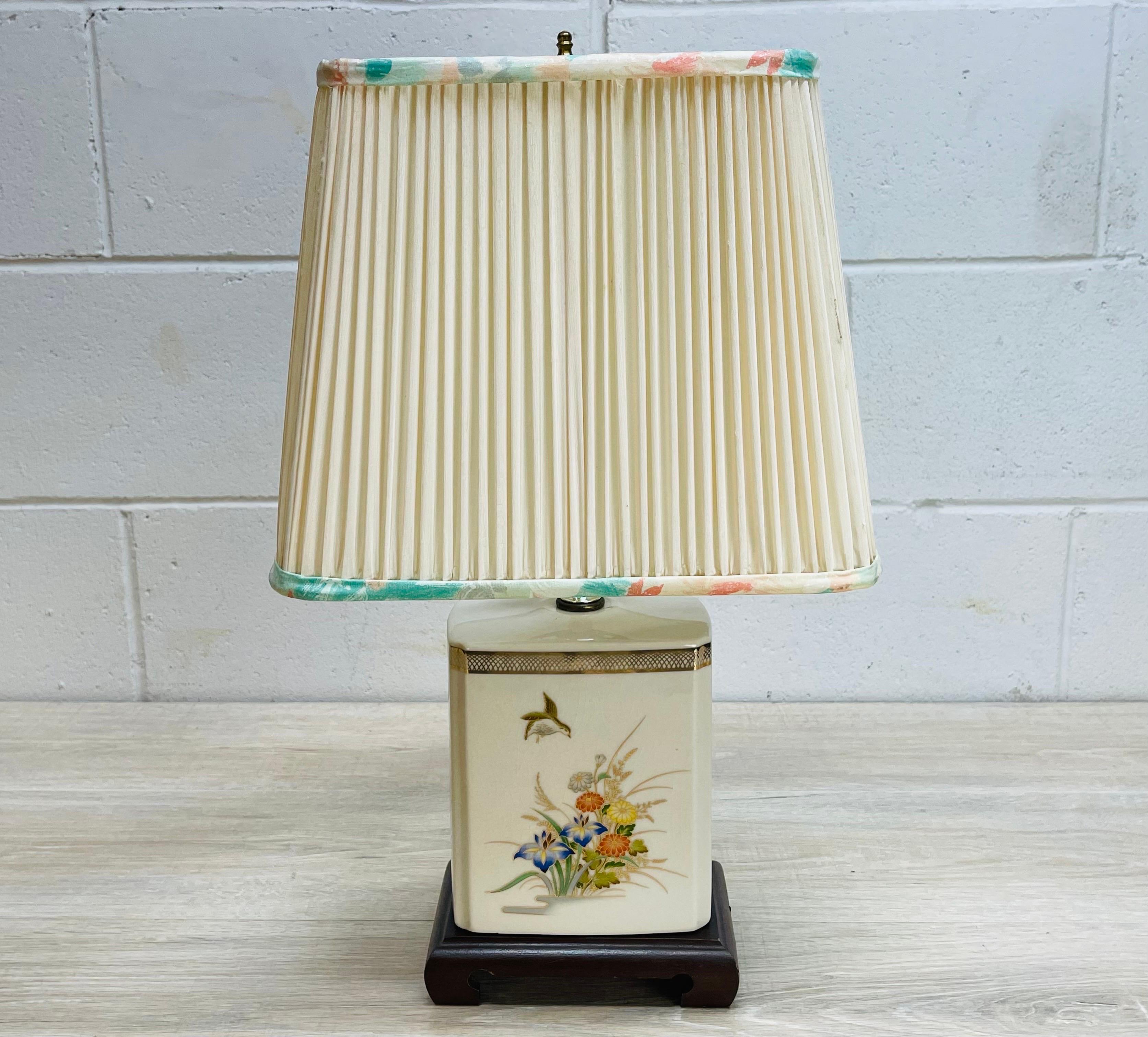 Vintage 1980s floral ceramic Asian style table by Murray Feiss. The lamp comes with the matching shade. Wired for the US and in working condition. Shade measures 12” x 8” x 10”. Socket, 13” H. Harp, 4.5” diameter x 7” height. Marked.