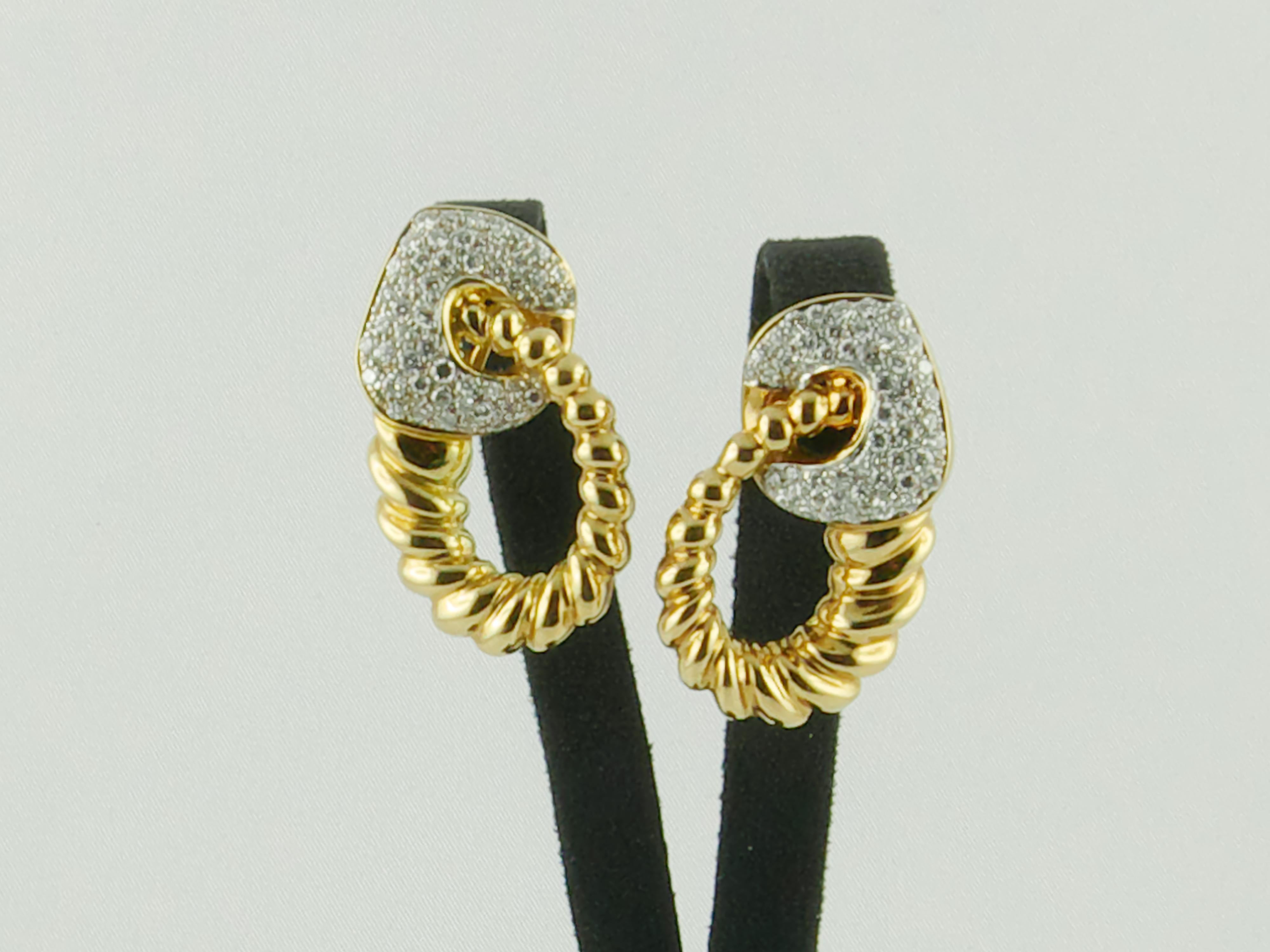 Pair of elegant 1980s  clip-on earrings finely crafted in Italy  in 18K Yellow and White Gold with a Graduating Fluted swirl design  