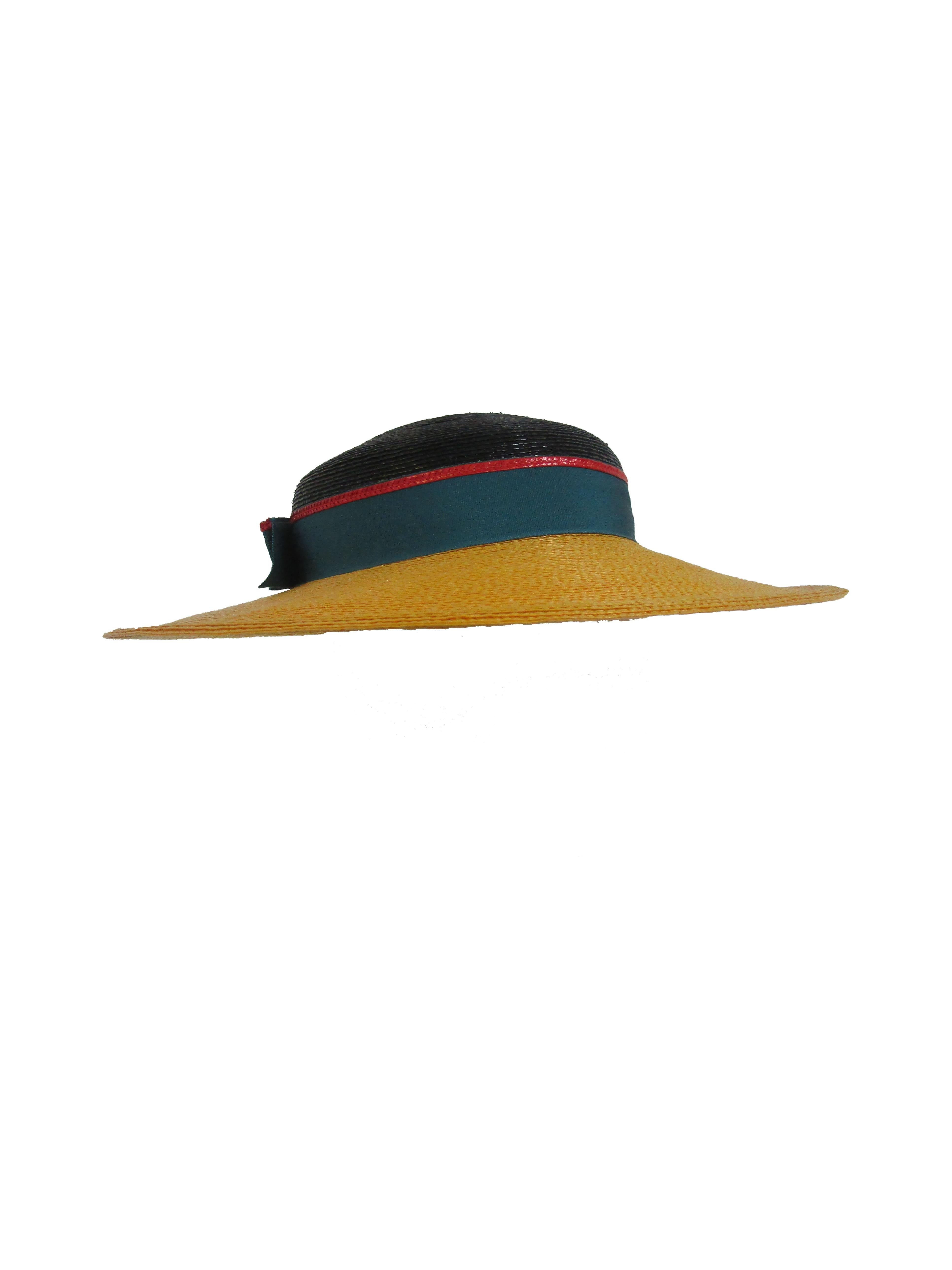1980s Frank Olive Color Block straw hat with bow. 

Block the sun and heat in style with this Frank Olive with this fantastic straw hat!  It features a waxed raffia body, a wide brim and a grosgrain band with a styled bow.  

Make a statement on