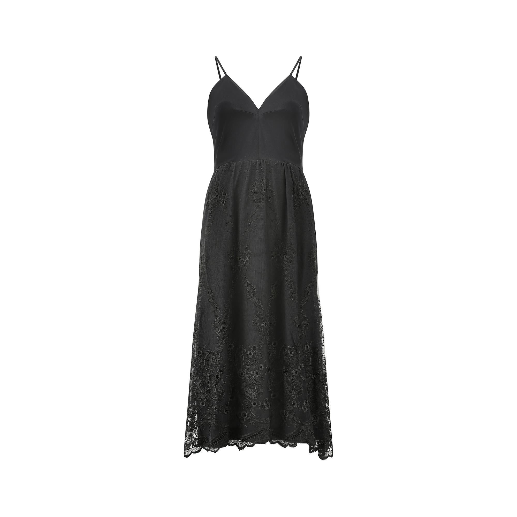 A good 1970s black slip dress by British heritage brand Frank Usher, perfect for a black tie or cocktail event. It has spaghetti straps, and a fitted bodice with a V neck front. The back is cut slightly lower, creating a flattering and feminine