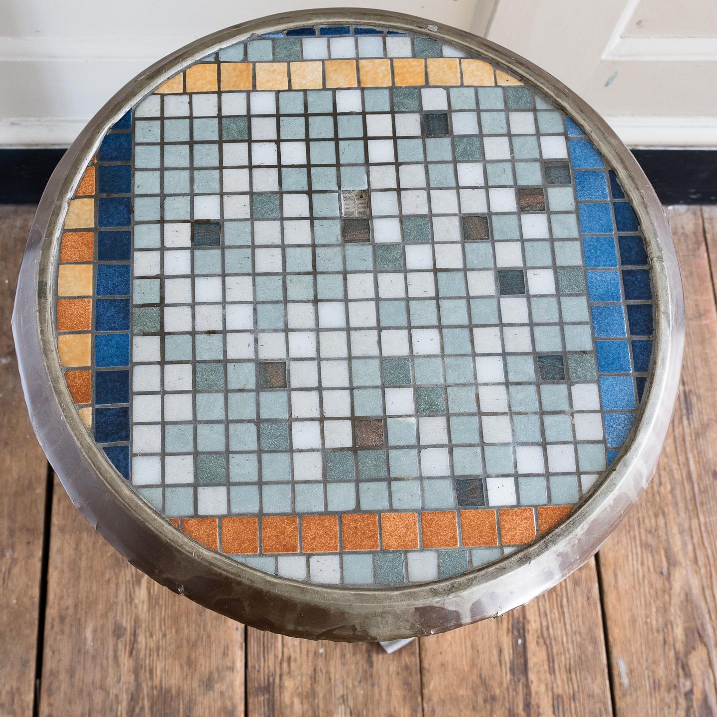 A 1980s French aluminium cafe table, with mosaic top (some tiles missing), on columnar base.