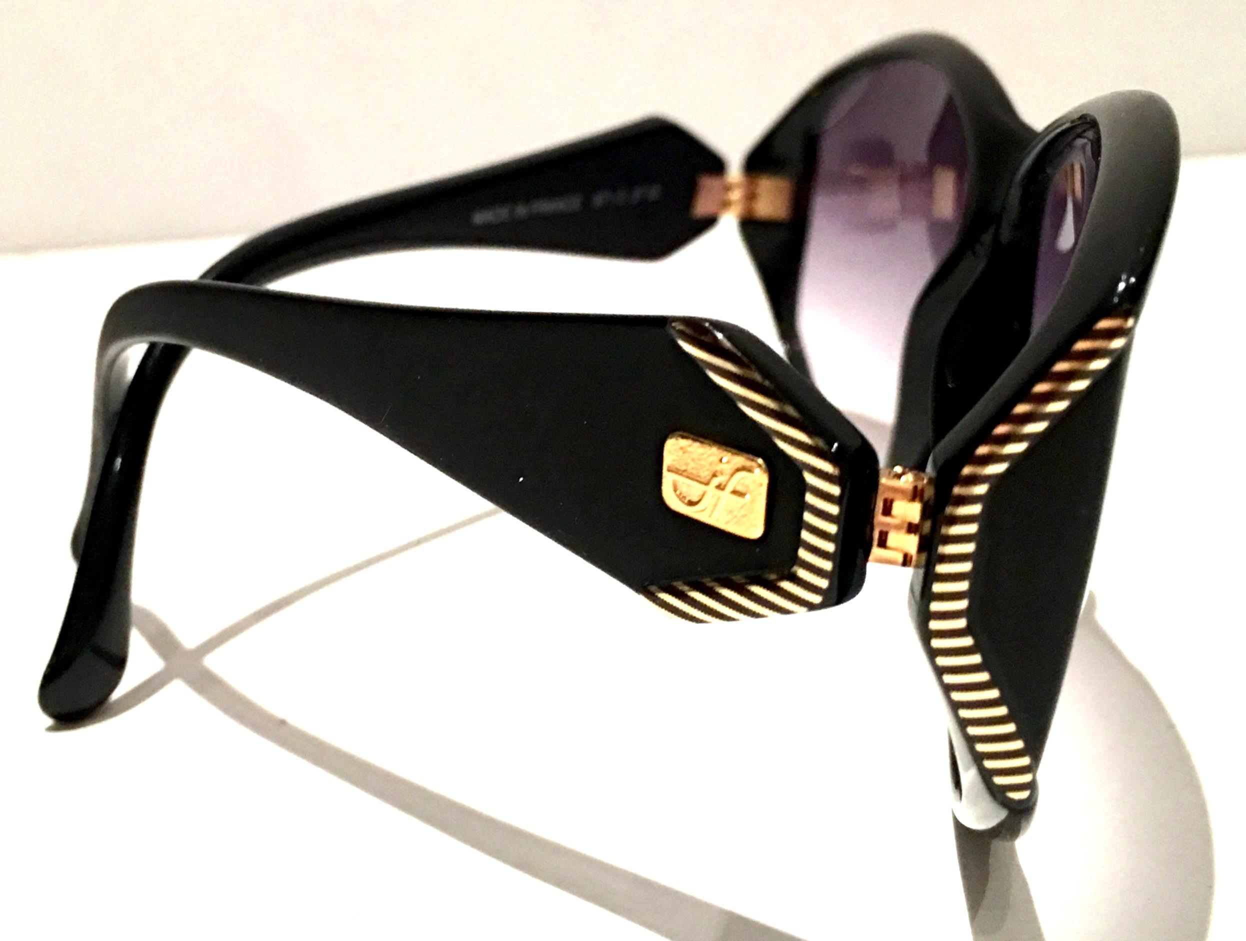 1980'S Jacques Fath French Black, Gold & Amethyst gradient  unisex sunglasses. Features raised gold plate detail and applied 