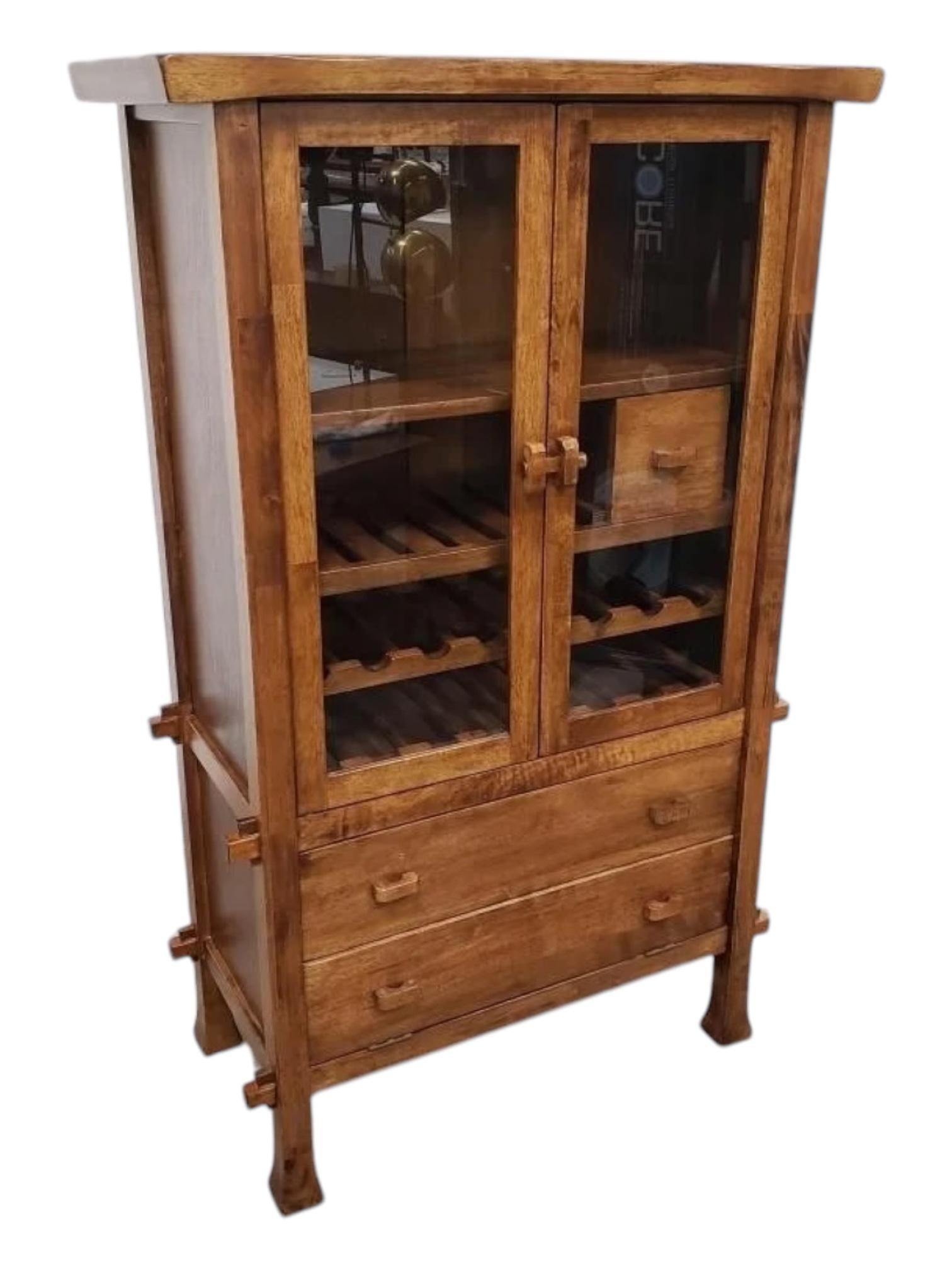 Add a touch of vintage sophistication to your home with this 1980s Country French Wine Rack Cabinet. Crafted with timeless elegance, this piece embodies the warmth and charm of French countryside aesthetics. Constructed from solid wood with a