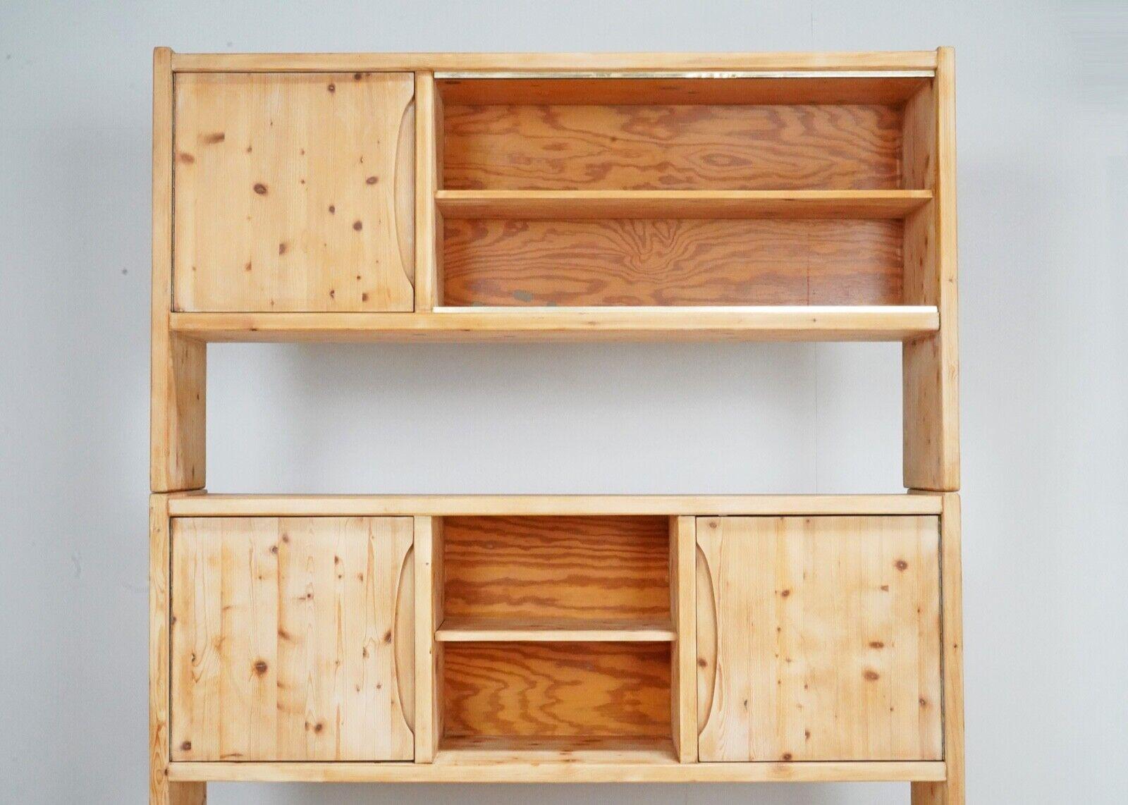  French pine shelving unit made from solid pine. 
Dating from around the 1980s.
It has been stripped in the past taking it back to bare wood.
The three tiers of the unit can be lifted off as they locate on wooded dowels. 
The doors close and are