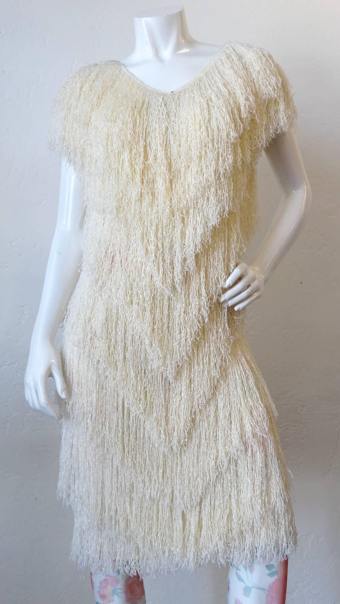 Shake it up with this amazing 1980s French Rags hand looked fringe dress! Long layers of fringe down the entire dress, draping over each of the shoulders. This piece has incredible movement, it flows as you strut! Pair with your favorite belt and