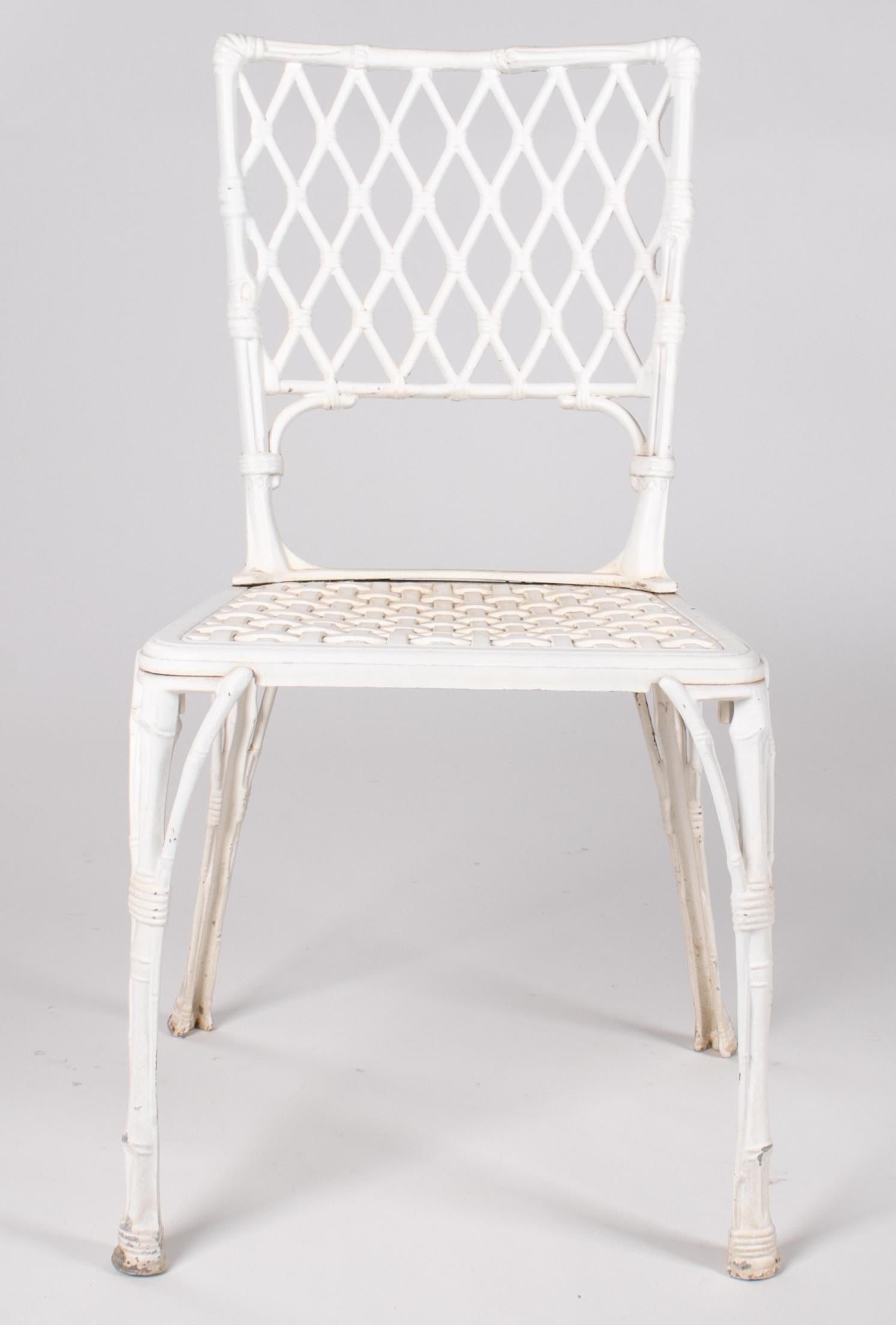 1980s French set of eight white painted aluminium chairs with rhombus pattern back, rattan and bamboo imitating seat and legs.



 