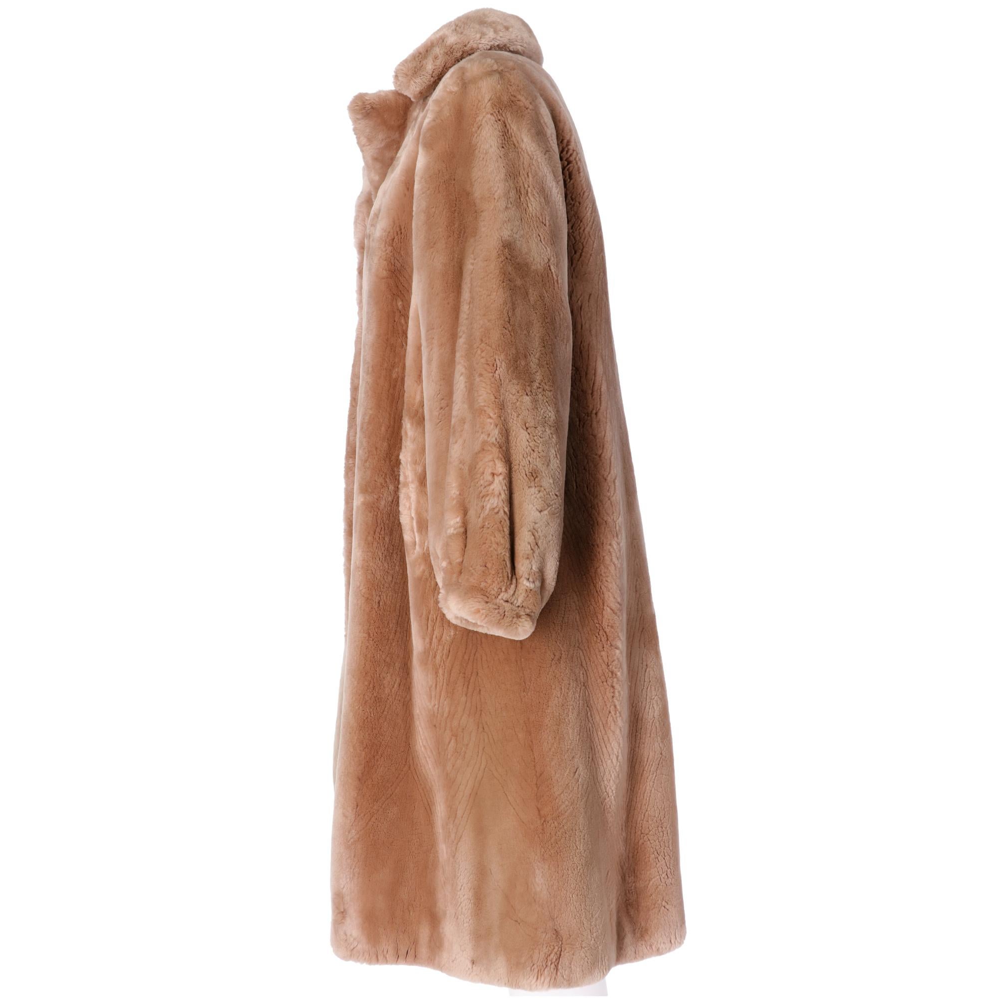 Balzani fur cape long below the knees, in real dyed beige beaver fur, with classic lapels collar, front welt pockets, front lacing with hook and eyelet, beige fabric lining with embroidered initials.


Please note this item cannot be shipped outside